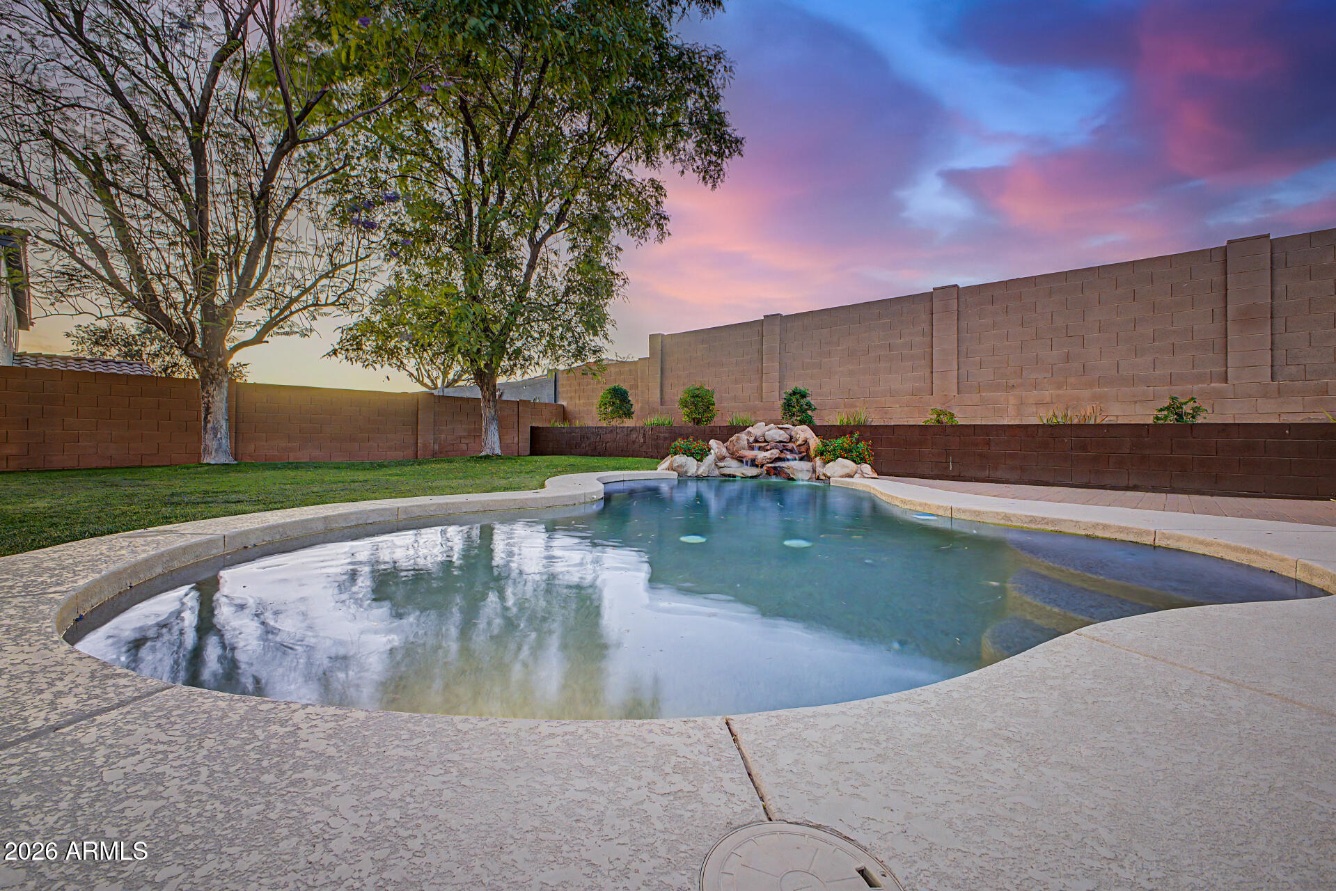 Welcome home to the perfect blend of comfort, convenience, and modern Arizona living! Ideally located with quick access to Loop 303 and Loop 101, this move-in ready home is perfect for anyone looking to be near the new semiconductor/chip manufacturing corridor while staying close to shopping, restaurants, parks, and entertainment. Inside, you'll find an open-concept great room designed for easy everyday living and entertaining. The kitchen features quartz countertops, ample cabinetry & storage space, and an eat-in dining area. The main-level den/office offers excellent flexibility for working from home, a playroom, or guest space. Upstairs, enjoy a spacious bonus/game room ideal for movie nights, gaming, or a pool table setup. The oversized primary suite includes a sitting area, updated walk-in shower, dual sinks, and TWO walk-in closets. Two additional guest bedrooms provide comfortable space, including one with its own walk-in closet. Step outside to your private backyard oasis featuring a sparkling pool and lush green grass perfect for relaxing or entertaining. Brand new AC units provide year-round comfort, while leased solar helps keep energy costs manageable. Excellent location near major freeways, top employers, shopping, dining, and everyday conveniences!