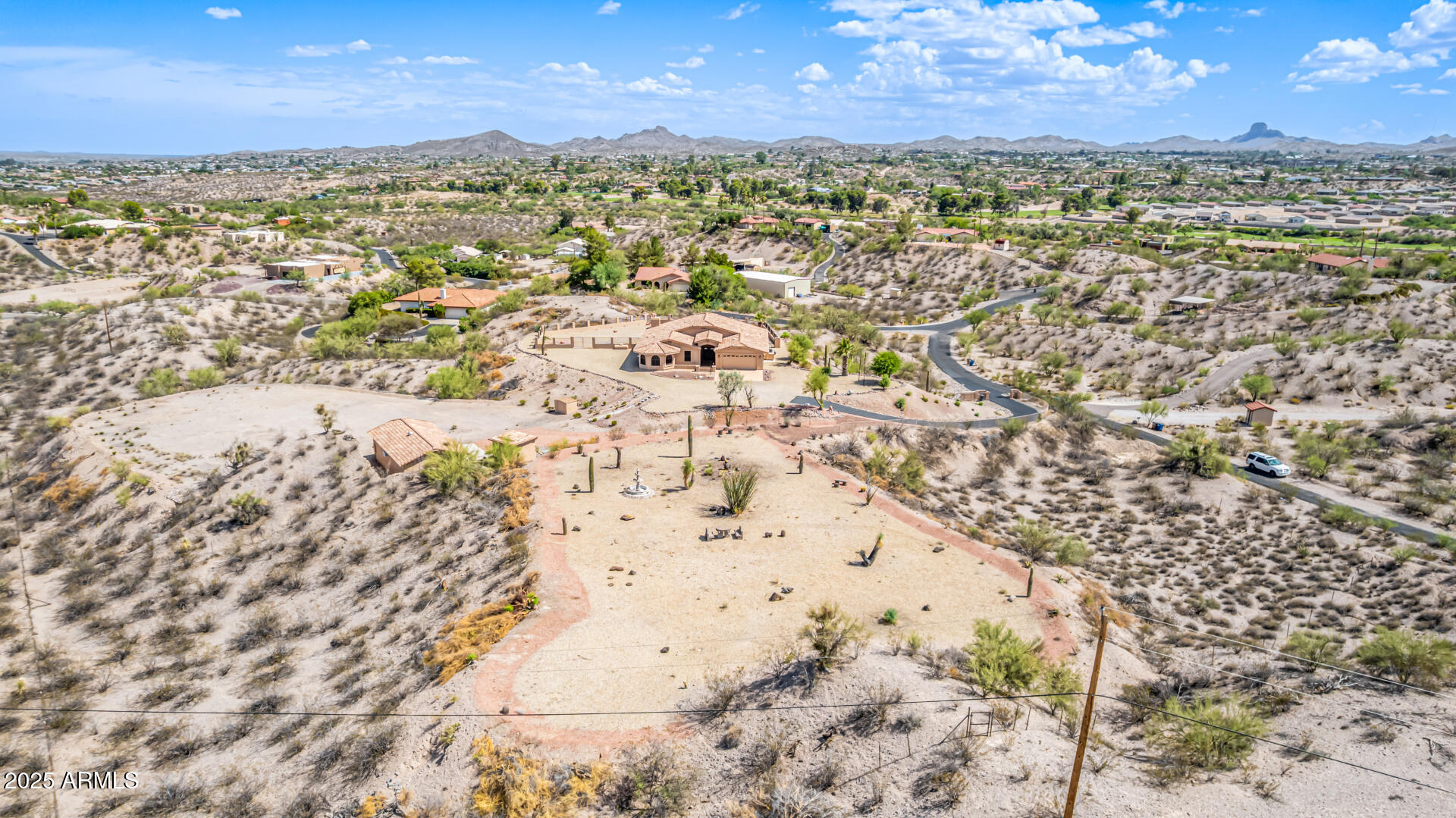 Beautiful 360 degree Million Dollar VIEW ''ONE OF A KIND''  w/2 additional lots Bulk sale 505-05-002U & 505-05-002Y total acreage just under 7 acres. -BEAUTIFUL ready to build lots with water & electricity-Stunning  property with breathtaking view of Vulture Peak- complete privacy - separate detached 800+ sq foot building- easement driveway to pump & electrical transformer - perimeter fencing on all acreage with electric security gate - cameras in place for future additional security (monitored security system owned) -Enter the house through expansive foyer to the great rm & dining rm w/vaulted ceilings & view of the play pool & surrounding views - remodeled kitchen w/NEW appliances, updated cabinets overlooking large, beautiful family rm w/fireplace AMAZING HOME!