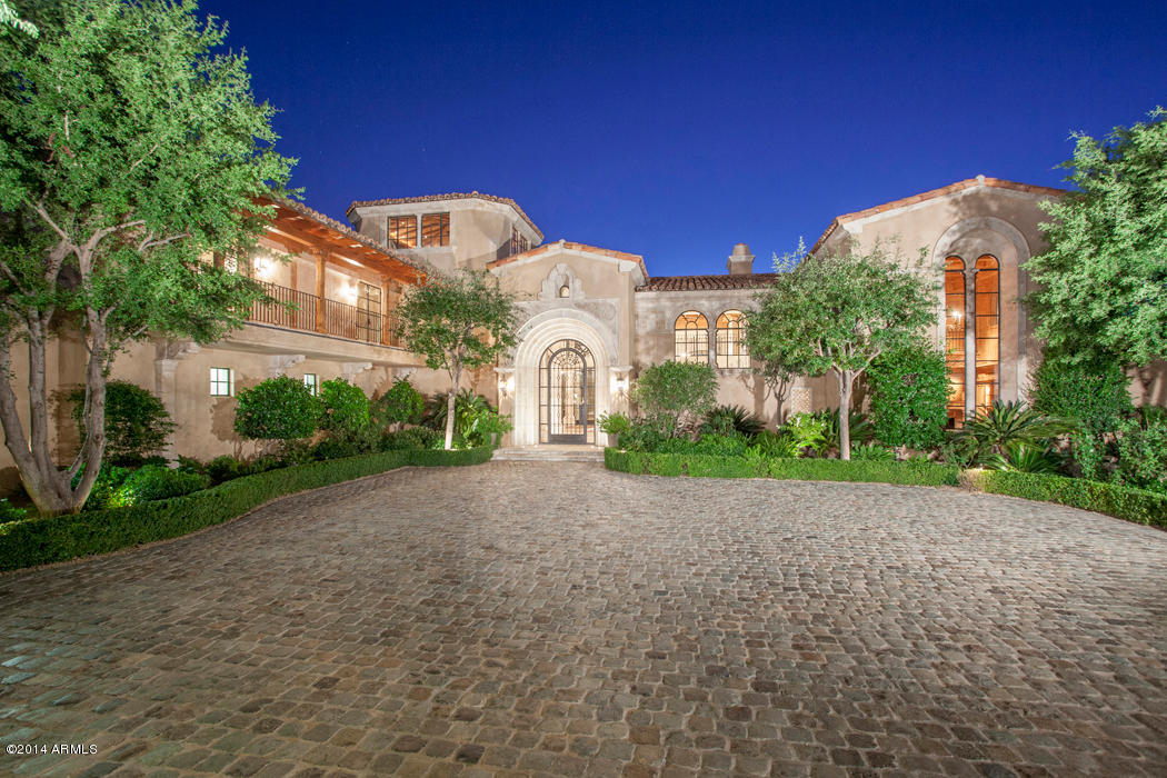 A breathtaking setting offering mountain, city, & sunset views is only the beginning of this magnificent home located within the premier North Scottsdale gated community of Silverleaf. This home is the epitome of luxury living. The quality of the construction and luxurious finishes enhance the unique floor plan. You arrive through your private gated entry highlighted by reclaimed cobblestone pavers. A massive iron door reveals an elegant living room & stunning walls of hand forged iron framed windows. Only the finest imported interior finishes have been used including original French limestone, “Scrumpy Jack” oak wood flooring, Turkish custom-made columns, detailed oak coffered ceilings and a two story library with hand-carved pine wood paneling. **Click more for additional comments** The master suite features a private serenity garden, dog run, exercise room and lavish bath. The 5 star kitchen boasts high-end appliances, rich furniture-quality cabinetry, imported pewter countertops, a spacious butler's pantry and office. The limestone staircase and walkway leading to the guest level is surrounded by custom Rob Gunter iron railings. The 3rd level lookout tower offers 360 degree views of the preserve, golf fairways, and amazing views of city lights. The two room guest house is a short walk along a brick pathway through a desert garden. It is a unique achievement, a full redefinition of today's luxury home.