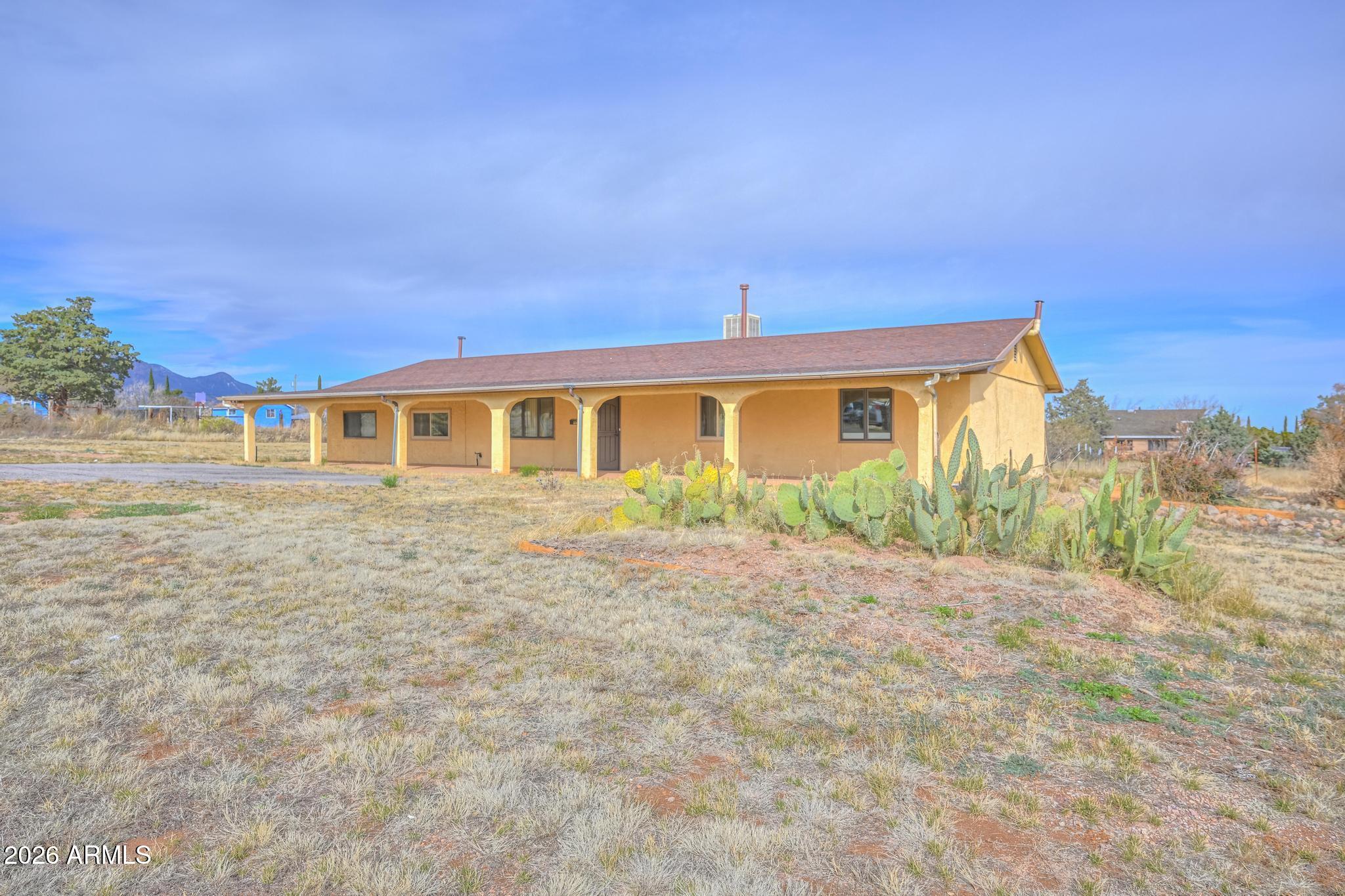 Seller offering a credit toward the installation of central air conditioning upon acceptable contract! Looking for space, privacy, and endless possibilities? This charming Hereford property sits on a full acre with breathtaking mountain views and plenty of room to create the lifestyle you've been dreaming of. Whether you need space for RV parking, a workshop, gardening, chickens, recreational toys or simply room to spread out, this property offers the flexibility to make it your own. Imagine relaxing with your morning coffee while taking in the stunning mountain scenery or spending evenings enjoying Arizona's beautiful sunsets from your own backyard. Inside, you'll find comfortable living spaces, including a large Arizona room that offers additional space for entertaining, hobbies, or relaxing year-round. If you've been searching for a property that offers country charm, mountain views, privacy, and room for all your animals, projects, and outdoor pursuits, this is one you won't want to miss.
