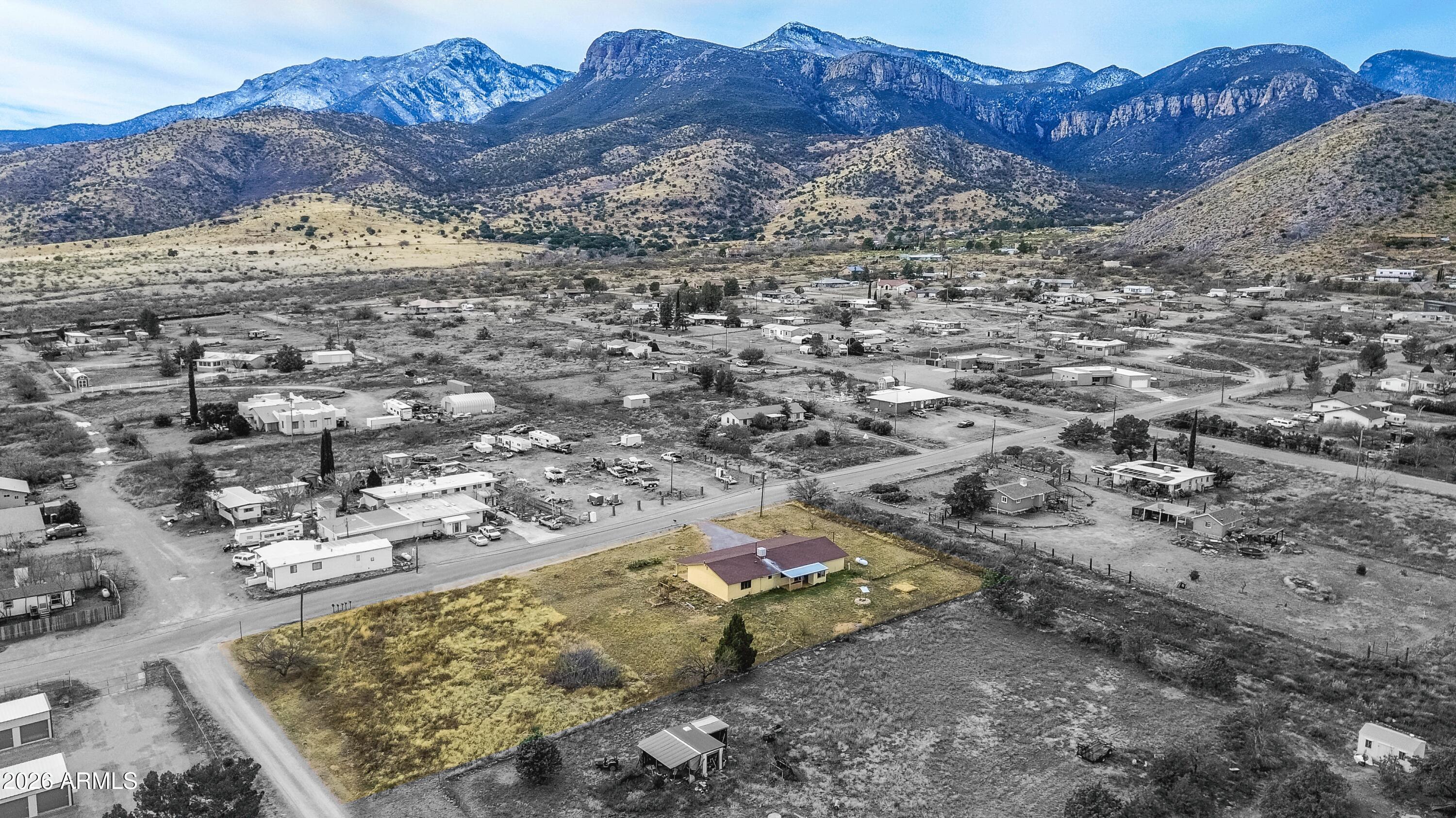 Welcome to this spacious 3-bedroom, 2-bath home offering 2,385 sq. ft. of comfortable living space on over an acre with breathtaking Huachuca Mountain views. Designed with both functionality and entertaining in mind, this home features an expansive bonus room perfect for a game room, media space, home office, or cozy den.  A large covered front porch invites you into the open living and dining areas, creating a warm and welcoming atmosphere. The kitchen is well-equipped with abundant cabinetry and generous counter space, along with newer stainless steel appliances including the refrigerator and dishwasher. Outside, the property offers endless possibilities with plenty of room for RV parking, outdoor activities, and an attached workshop for hobbies or projects. Enjoy the serenity of country living while remaining conveniently close to town and Ft. Huachuca.