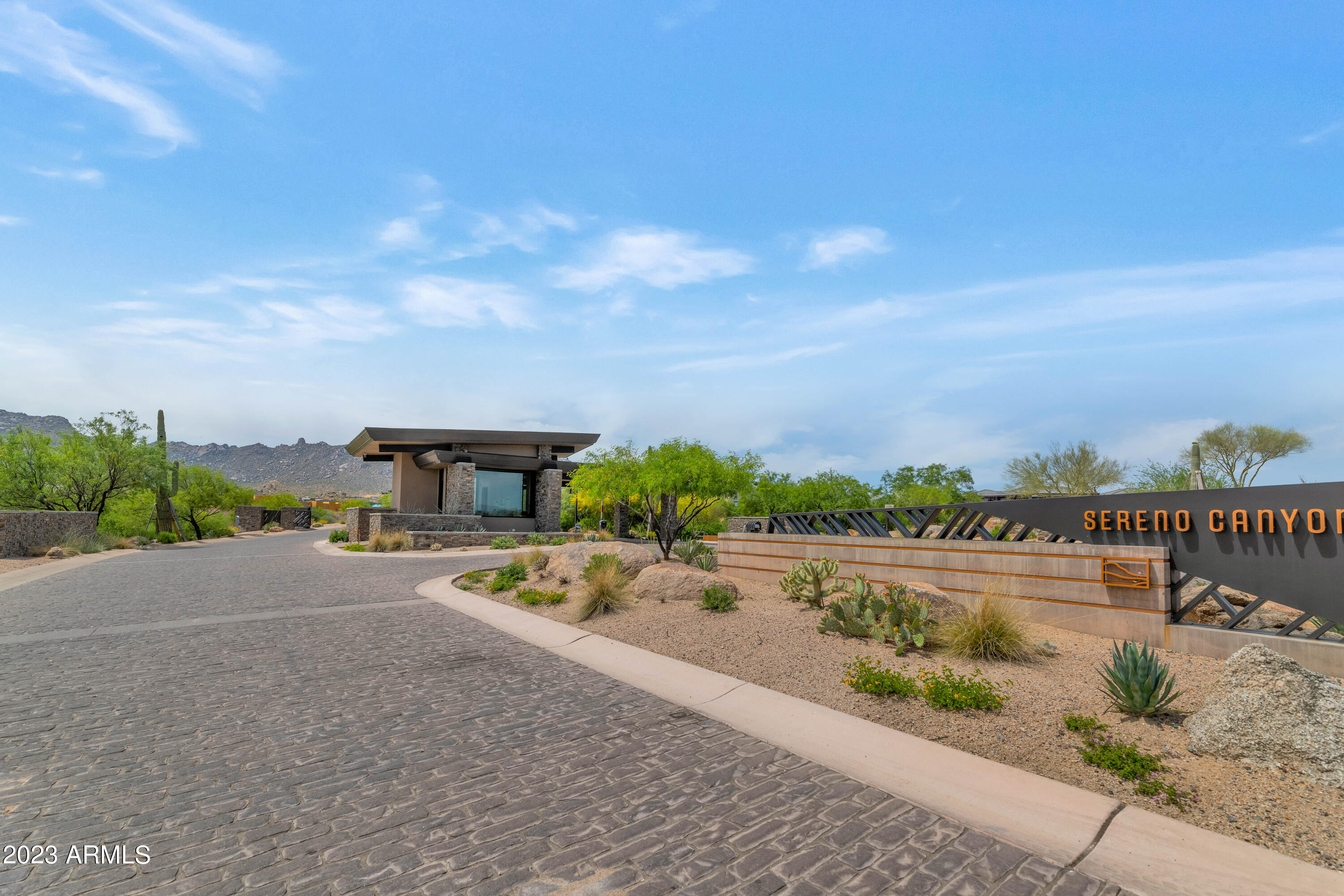 OVERALL SQ. FT. IS 5992! 5294 SQ. FT. IN THE MAIN HOUSE & 698 SQ. FT. IN THE GUEST QUARTERS/CASITA WITH PRIVATE ENTRANCE! Come live resort lifestyle at Sereno Canyon, a tranquil & secluded guard-gated community in North Scottsdale.  This property is set-back on this 2.22 acre lot which offers complete privacy.  Entrance road curves & leads back to residence. This Vacaro Desert Contemporary home sits on one of the premiere lots w/a lot premium of $250K. . showcases tremendous Mtn. views & Sonoran desert.  Living room, bedroom, bath & kitchenette and own HVAC. The master is split and three en-suites are positioned on the other side of the house w/secondary living space centered in this specific area.  Another highlight to this property is the large oversized 5-car garage!! Lead-off pictures show the recent landscaping installed on the property including the front courtyard, southwest tree and plants, and a scattering of a few plants in the backyard.  The back of the property has minimal landscaping, but for the most part this area has been left unfinished to allow the buyer to complete the backyard and install those elements that meet their needs.  This property can accommodate a pool/spa, ramada, outdoor kitchen and potentially a view deck, whatever the buyer wants.  The owner chose to discount the house heavily so that the buyer can do a cohesive plan in the development of the backyard living spaces, etc. Sereno Canyon maximizes the experience of living in the Sonoran Desert with native plants, natural rock cropping's, access to trailheads, and a plethora of outside recreational activities.  This community hosts amenities like a landmark clubhouse with a fitness center, spa, full-service kitchen, bars and a café.  The club fashions indoor and outdoor spaces , and the facility will feature two swimming pools, cabanas, patios, and over 8500 square feet of covered terraces.  The makeup of the community has 134 townhomes, 128 villas, and 96 estate properties.  The sunsets are stellar and the desert lifestyle is a #10.