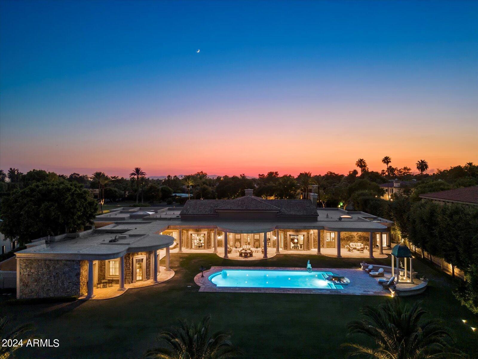 Record-Breaking VALUE Here at the prestigious Biltmore Resort; the Estates within the circle are majestic. This setting is exceptional on the golf course at 1.3 acres of breathtaking views of Camelback Mountain backdrop. A grand motor court welcomes you to a stately foyer, leading to expansive living and dining areas that epitomize opulence. The kitchen is a culinary marvel, boasting generous pantries and an extensive laundry suite. The private master suite offers a serene retreat, while additional rooms include a sophisticated office, an elegant library, and a refined bar room. Descend to the lower level to discover a magnificent paneled game room, an impressive wine cellar accommodating thousands of bottles, a chic bar, and a luxurious theater room. The verdant backyard, overlooking the golf course, features an outdoor kitchen perfect for alfresco dining and a charming two-bedroom guest house. This estate exemplifies exceptional craftsmanship, architectural brilliance, and an unrivaled location, making it a true masterpiece of luxury living.