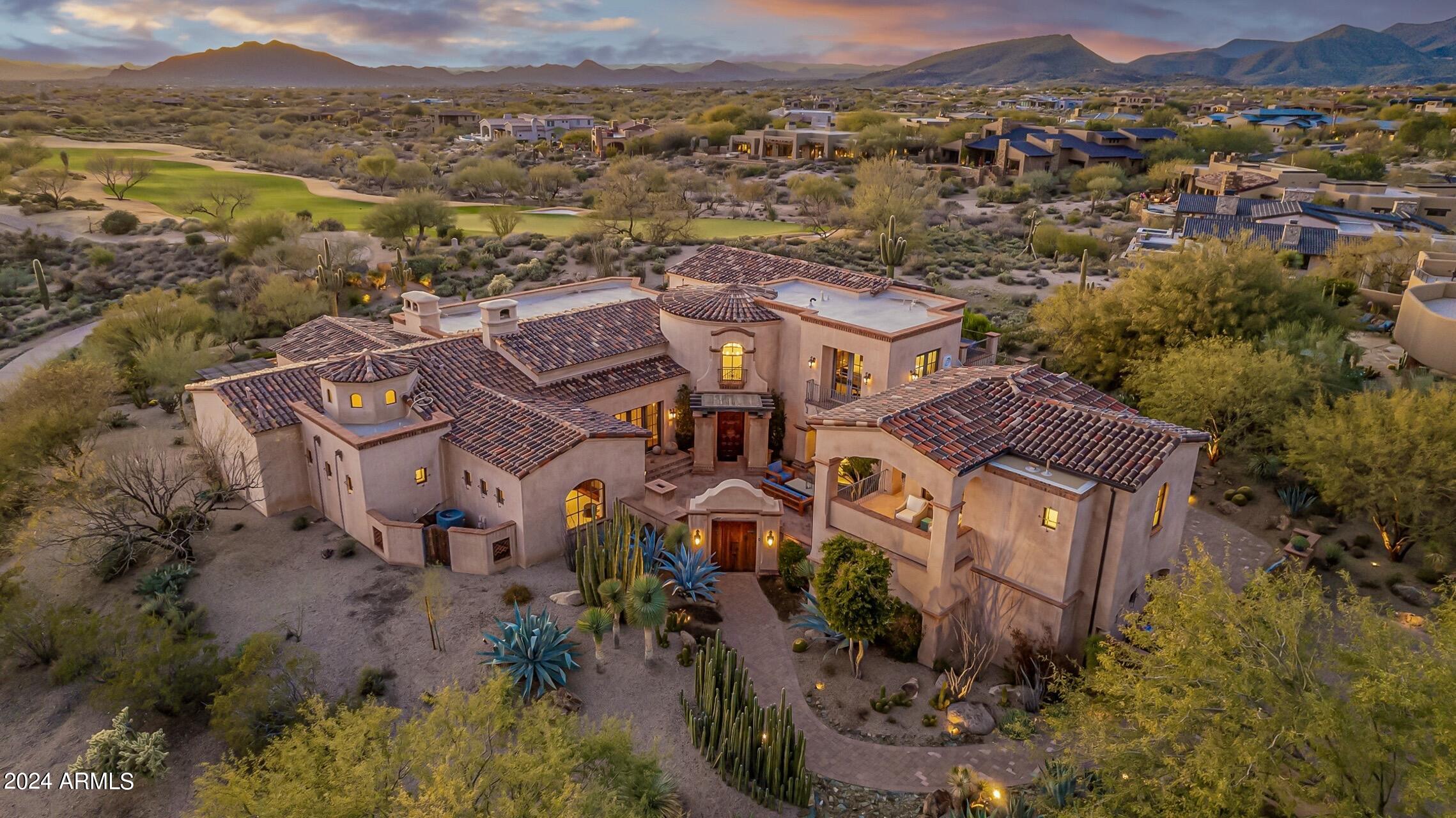 Step into the pinnacle of luxury living in this remarkable 6,500-square-foot masterpiece, a custom-built home by Beringer Fine Homes. Meticulously designed and impeccably crafted, this prestigious estate is located within the coveted award-winning Mirabel Golf Club, offering breathtaking mountain and city light views on the 4th Green and the surrounding golf course. The Santa Barbara-style villa exudes timeless elegance and is professionally decorated by ODA Design Associates, setting the stage for a lifestyle of unparalleled sophistication. The heart of this exceptional home is the gourmet kitchen, featuring brand new Wolf Stainless Steel Built-In Double Oven/Microwave, a Wolf Gas Stainless Steel 6 Burner Range Top, and a Built-In Sub-Zero Refrigerator/Freezer. Dual ASKO dishwashers, Grohe faucets, and a Miele Stainless Steel Built-In Espresso/Coffee Machine elevate the culinary experience. New quartz countertops and a large center kitchen island with a custom granite countertop provide ample space for cooking and entertaining. The great room is a masterpiece, with a custom-built large fireplace, a dramatic 15-foot ceiling adorned with wood beams, and large bi-fold doors that seamlessly blend indoor and outdoor living. Retreat to the primary bedroom, a haven of comfort with a custom-built large fireplace, automatic drapes, and access to the outdoor patio and pool area. The primary bathroom is a spa-like oasis, boasting a self-cleaning soaking/jetted tub, dual/separated vanities, a dressing table, and a large walk-in shower with three custom shower heads. The backyard is an entertainer's dream, featuring a large, covered patio with an outdoor fireplace, a firepit, and an automated heated pool, spa, and fountains. The infinity-edge pool beckons for a refreshing swim, and two built-in BBQs (one gas and one charcoal) cater to your culinary desires. Enjoy the convenience of the outdoor pool bathroom and the five-hole putting green. This extraordinary estate offers a level of luxury and craftsmanship that must be seen to be fully appreciated. It represents the acme of high-end living, providing the ultimate in comfort, style, and elegance. Welcome home to a life of indulgence and distinction.
Social Membership Transferable and Golf Membership Available per the Mirabel Club Bylaws.