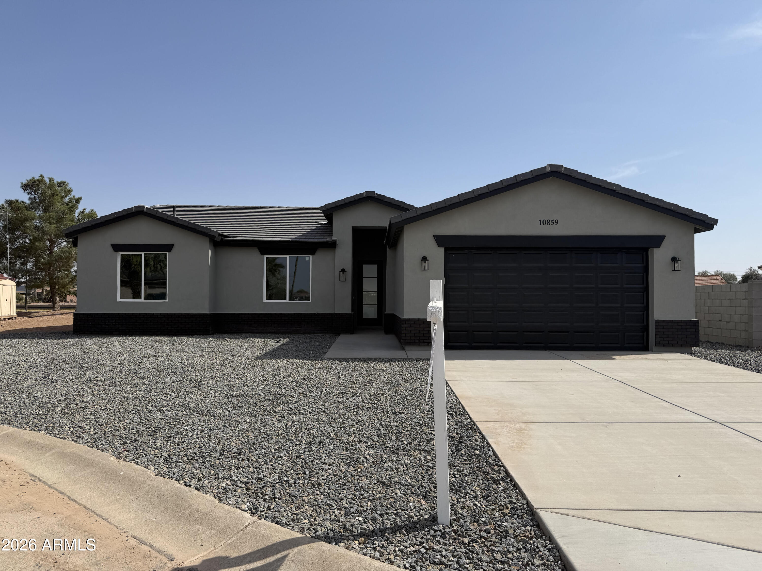 Brand-new lakefront home in Arizona City offering 4 bedrooms, 2 baths, and approximately 1,700 sq ft of modern living space. Open-concept design features a spacious kitchen with quartz countertops, large island, white shaker cabinetry, stainless steel appliances, tile backsplash, and recessed lighting. Luxury laminate flooring flows through the main living areas. Primary suite offers lake views, a sliding glass door to the backyard patio, dual-sink vanity with quartz counters, and a walk-in tiled shower. Located on Paradise Lake, a 48-acre residential lake with a mega fountain and abundant wildlife. Interior is complete. Final exterior improvements underway with anticipated move-in around March 7th. Approximately 50 miles from Phoenix and Tucson.