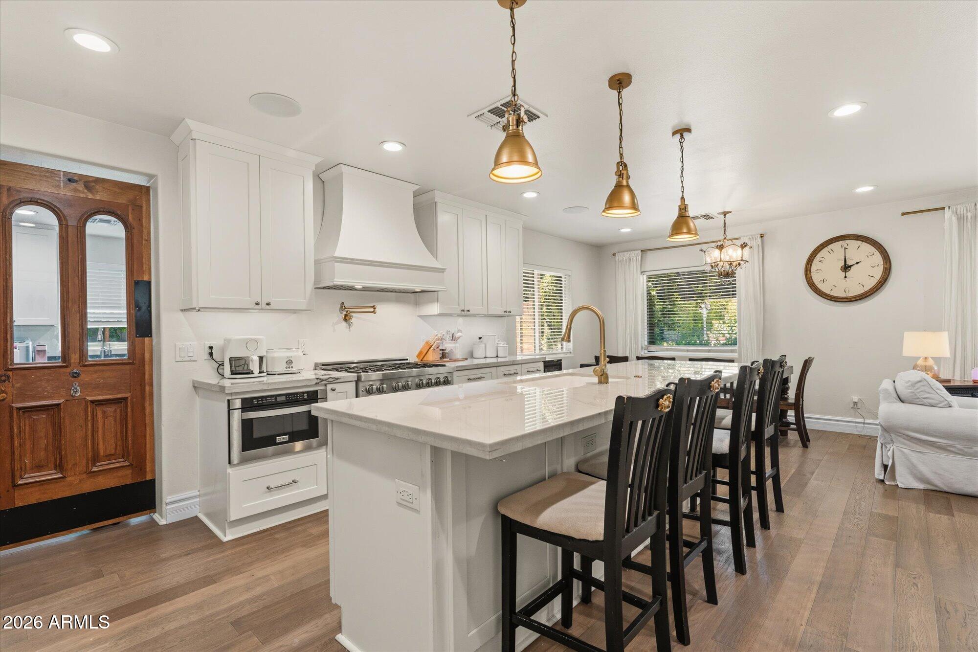 Completely reimagined in 2020, this exceptional University Park residence blends timeless design, modern luxury, and effortless indoor-outdoor living in one of Tempe's most sought-after neighborhoods, where opportunities to own are few and far between. Thoughtfully expanded and extensively remodeled, the home now offers 4 bedrooms, 3.5 bathrooms, and an open-concept floor plan designed for both everyday living and sophisticated entertaining.

At the heart of the home, the beautifully appointed kitchen showcases a Sub-Zero refrigerator, ZLINE professional range, generous workspace, and seamless flow into the expansive living and dining areas. Just beyond, an impressive family room is highlighted by a collection of distinctive vintage chandeliers, creating a warm and memorable gathering space that opens directly to the professionally designed outdoor retreat.

The backyard, masterfully crafted by Berghoff Design Group, is a private oasis featuring mature trees, lush low-maintenance turf, a custom fire pit, and exceptional privacy--an inviting setting for quiet evenings, entertaining guests, or enjoying Arizona's beautiful weather year-round.

Designed with both function and comfort in mind, the split-bedroom layout offers spacious retreats with generous closets throughout. A large walk-in pantry, oversized laundry room with dual washer and dryer sets, and abundant storage add convenience rarely found in homes of this caliber.

Situated on a generously sized lot, the property also offers five dedicated slab parking spaces plus two transferable street parking permits, providing an exceptional parking advantage in this highly desirable location.

Ideally positioned just minutes from Arizona State University, University Park is celebrated for its tree-lined streets, eclectic architecture, and vibrant walkable atmosphere. Residents enjoy convenient access to Mill Avenue's acclaimed restaurants and boutiques, Tempe Town Lake, neighborhood cafés, parks, multiple Valley Metro light rail stations, and major freeway connections, placing the very best of Tempe within easy reach.

Offering a rare combination of thoughtful design, premium finishes, exceptional outdoor living, and an unbeatable location, this is a truly distinctive opportunity in one of Tempe's most established and desirable neighborhoods. Offering a rare combination of modern luxury, exceptional outdoor living, and an unbeatable location in a neighborhood where opportunities are few and far between, this is a home that truly stands apart.