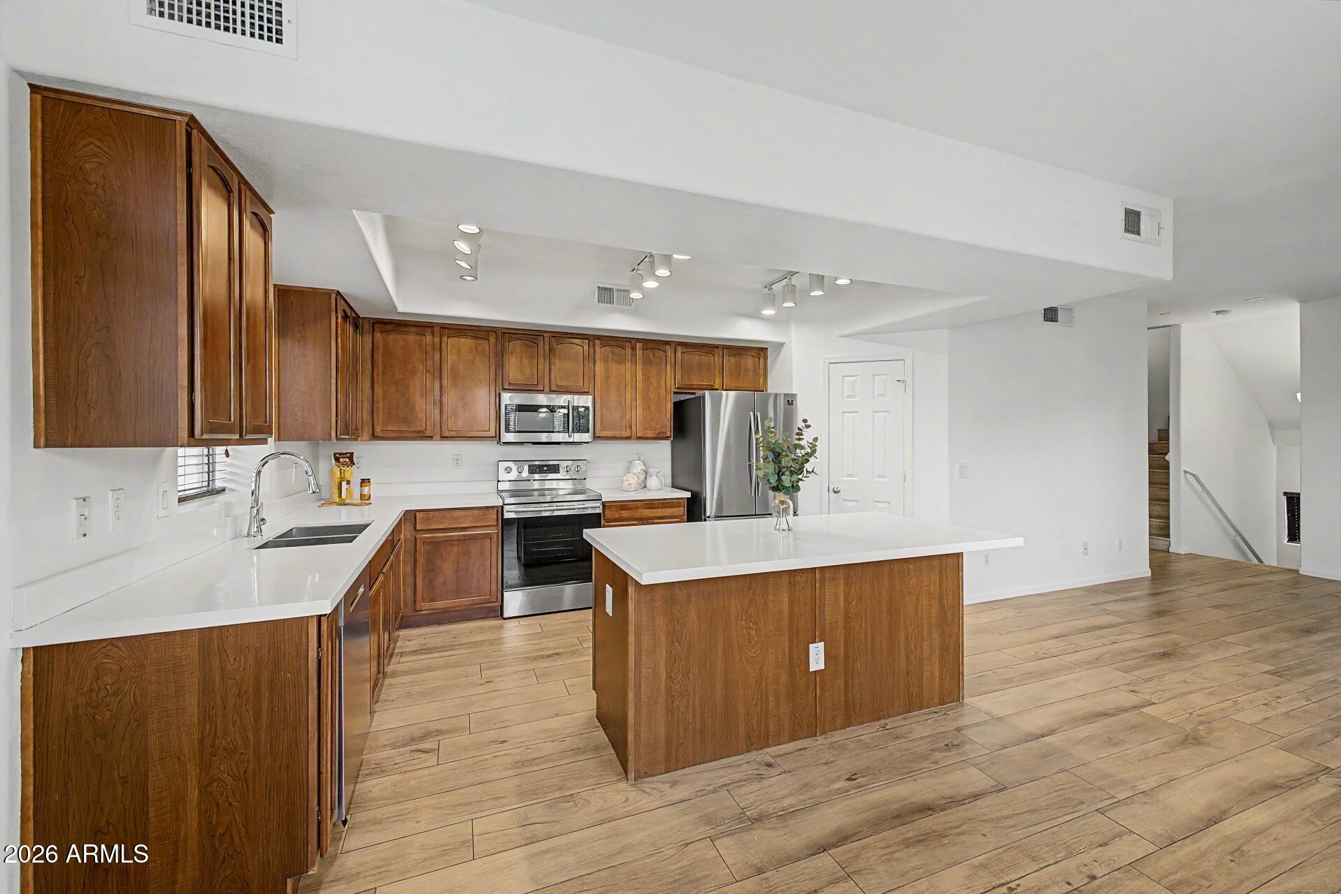 Welcome to this beautifully designed three-level condo offering both privacy and functionality. This home features a versatile layout perfect for modern living. Gorgeous bright kitchen with stainless-steel appliances, stunning counters, walk-in pantry, breakfast bar, and plenty of space for gatherings, creating the perfect setting for entertaining or relaxing. Upstairs bedrooms provide a peaceful retreat with separation from the main living spaces. Residents of the community have access to two sparkling pools, multiple playgrounds, a Ramada and a BBQ area, and enjoy close proximity to shopping, dining, and everyday conveniences. Located within a highly sought-after neighborhood known for its top-rated schools, this property offers an exceptional blend of comfort, convenience, and lifestyle