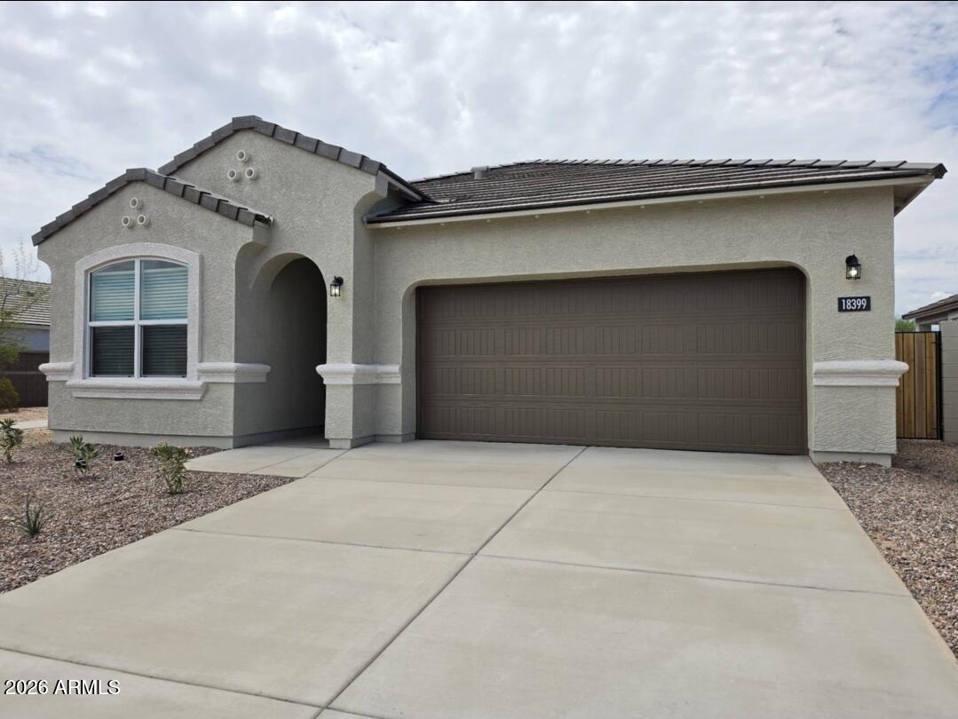 Be the first to enjoy this beautiful brand-new home located in Wittmann/Surprise, AZ. Offering 1,743 square feet of thoughtfully designed living space, this 4br, 2ba home combines modern style with everyday comfort.

The open-concept floor plan features an inviting kitchen with elegant quartz countertops, ample cabinetry, and seamless flow into the spacious living and dining areas. Durable tile flooring enhances the main living spaces, while large windows provide abundant natural light throughout.

Additional highlights include a 2-car garage with an epoxy-coated floor, creating a clean, durable finish. A nearby neighborhood park offers convenient outdoor recreation just minutes from your doorstep.

If you're looking for a fresh, never-lived in home then be the first to occupy it & e