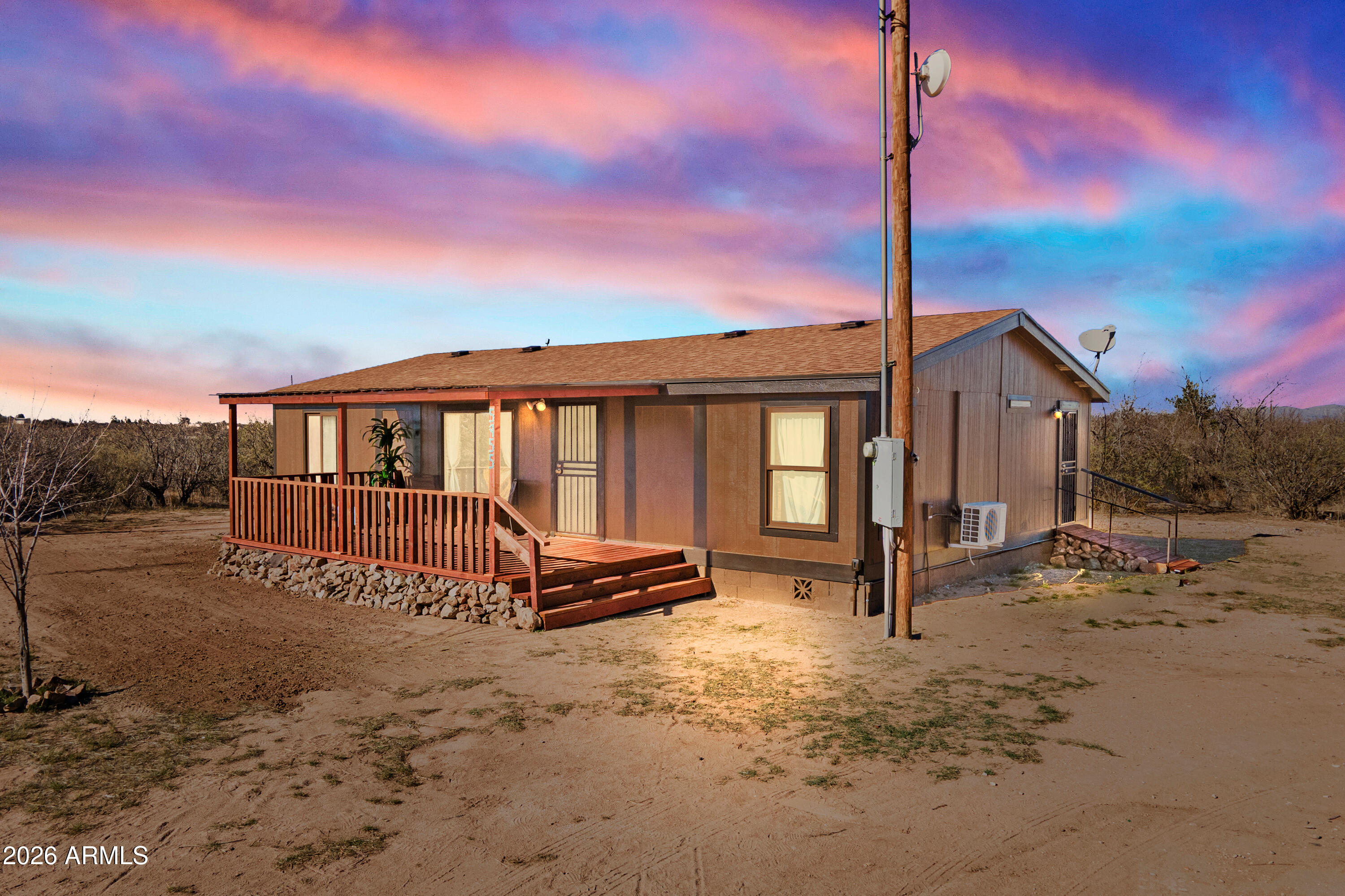 Nearly 5 Acres on a Corner Lot with Mountain Views. This beautifully updated, move-in ready three-bedroom, two-bath home offers the space and comfort of true rural living. Filled with natural light, the bright interior creates a warm and inviting atmosphere throughout. The heart of the home features a welcoming kitchen designed for gathering and everyday connection. The elevated covered front porch showcases breathtaking mountain vistas and peaceful surroundings -- the perfect place to relax and take it all in. The fully fenced property with corral provides room for animals, gardening, or hobbies. A rare opportunity to enjoy privacy, open space, and room to grow.