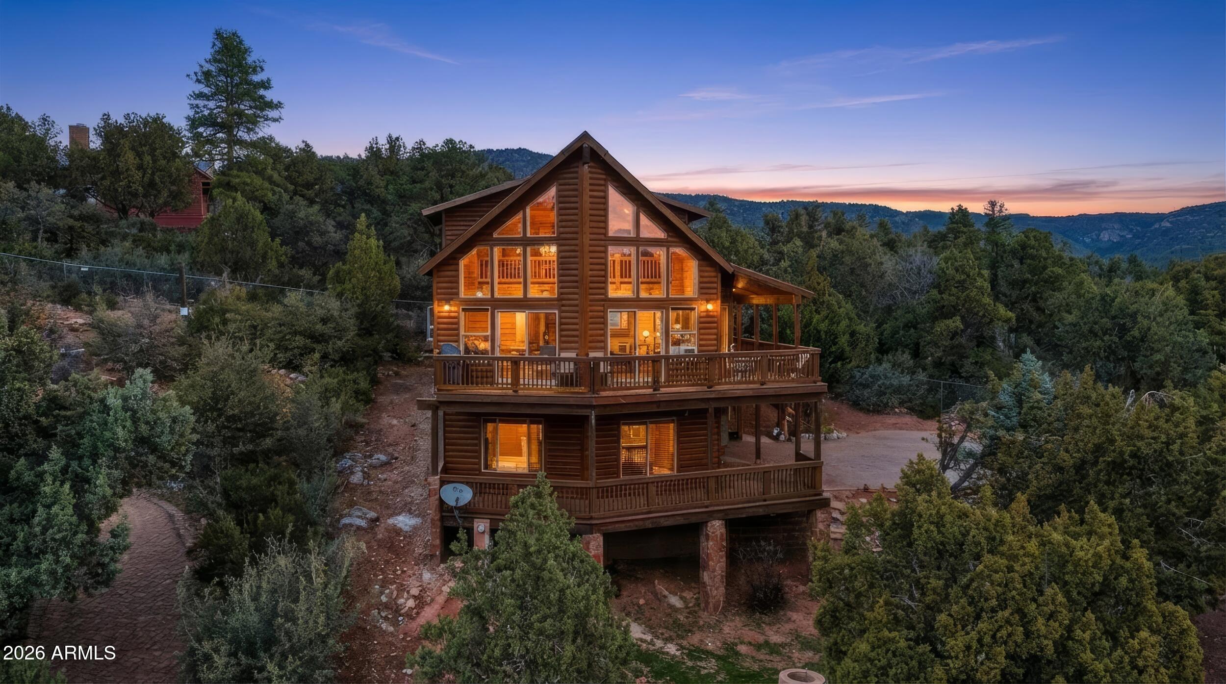 Sitting on Top of the World! 

Perched atop the Mogollon Rim, this beautifully updated log cabin delivers sweeping Mountain View's with a massive 180 degree composite deck, timeless rustic charm, and modern comforts--all with no HOA. Offering 3 bedrooms, 2 bathrooms, a loft, and an unfinished walk in basement, this home is the perfect blend of cozy retreat and functional living space.

The main level features an inviting great room with soaring wood-beam ceilings and picture windows that frame the surrounding forest and rim vistas. The granite kitchen was updated in 2023. The home has a cozy loft. 

The MBR has its own balcony, sitting area, walk in closet and more. 

$2,000 lender closing cost concession available to buyers financing with Lender With a Brain reduces buyer cash to