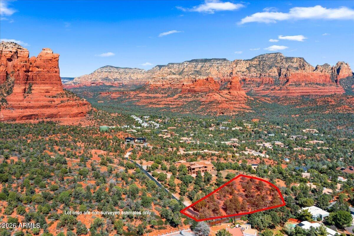Near the top of Sedona's coveted Soldier's Pass residential corridor sits something truly rare - a 0.9989 acre building lot within an exclusive 4-lot gated subdivision adjacent to the Coconino National Forest. From this elevated perch, the views stretch out for miles across some of Sedona's most iconic red rock formations -- Coffee Pot Rock, Brins Mesa, Wilson Mountain, and the Mogollon Rim -- a panorama that takes your breath away. You'll be able to hike right from your front door onto National Forest land and endless miles of trails around these iconic red rocks. This is an easy-build lot with a gentle slope and plenty of space for an estate-size home. Water and underground electric utilities are already in place near the lot line. The private paved road has recently been resurfaced. Two of the four lots have estate-size homes on them. No HOA (buyer to verify).
Opportunities like this are rare off Soldier's Pass, the most highly sought-after luxury corridor in Sedona, with very few vacant land parcels remaining in this special area. Located just a few minutes from Whole Foods and all the conveniences of west Sedona.
Few places offer the chance to build a lasting legacy amid this level of natural beauty, privacy, and prestige -- this is one of them.