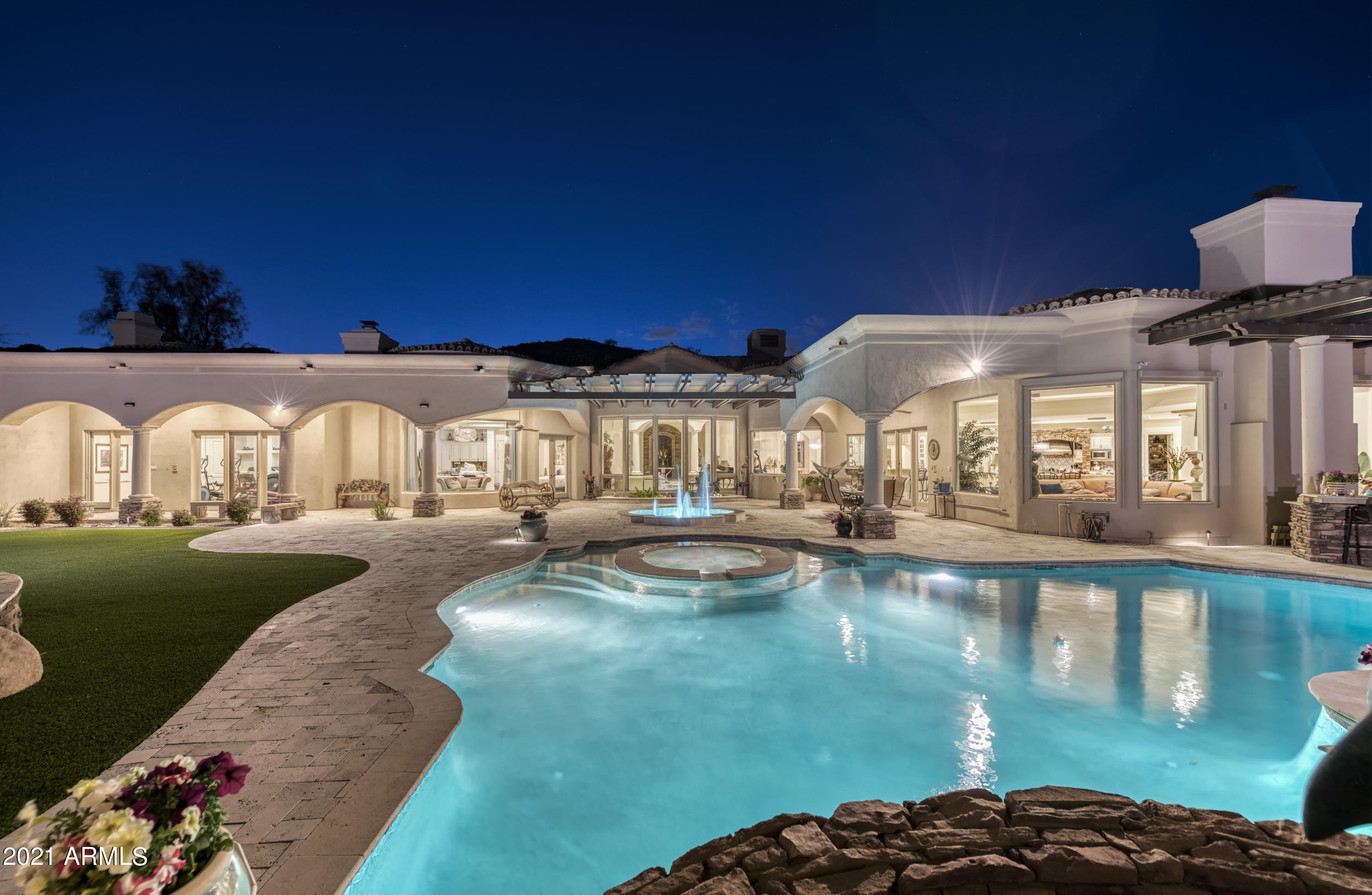 Set in a quiet, exclusive cul-de-sac - and highly private - Paradise Valley locale, this custom estate begs you to step inside to generous living. Surround yourself with unparalleled views and ultimate privacy, offering expansive entertaining options and flow. Superior quality and romance mix enchantingly with a visionary u-shaped floorplan, creating a logical lifestyle flow – inviting natural light and easy indoor/outdoor access. Sense of arrival is unique and flawless via the porte-cochère and extended 4-Car Garage. A magnificent entry hosts voluminous ceiling heights and views to surrounding mountain vistas through majestic picture windows throughout the residence.  The custom-built interior will house any personal style and offers an extraordinary chef's kitchen and open family room... ....Thoughtfully placed master suite and split ensuite bedrooms, including a separate entrance suite with kitchenette. The lavish theater, surround sound, and Sonos system brings entertainment variety to an executive level. Custom selections/accents marry seamlessly in this understated setting.
