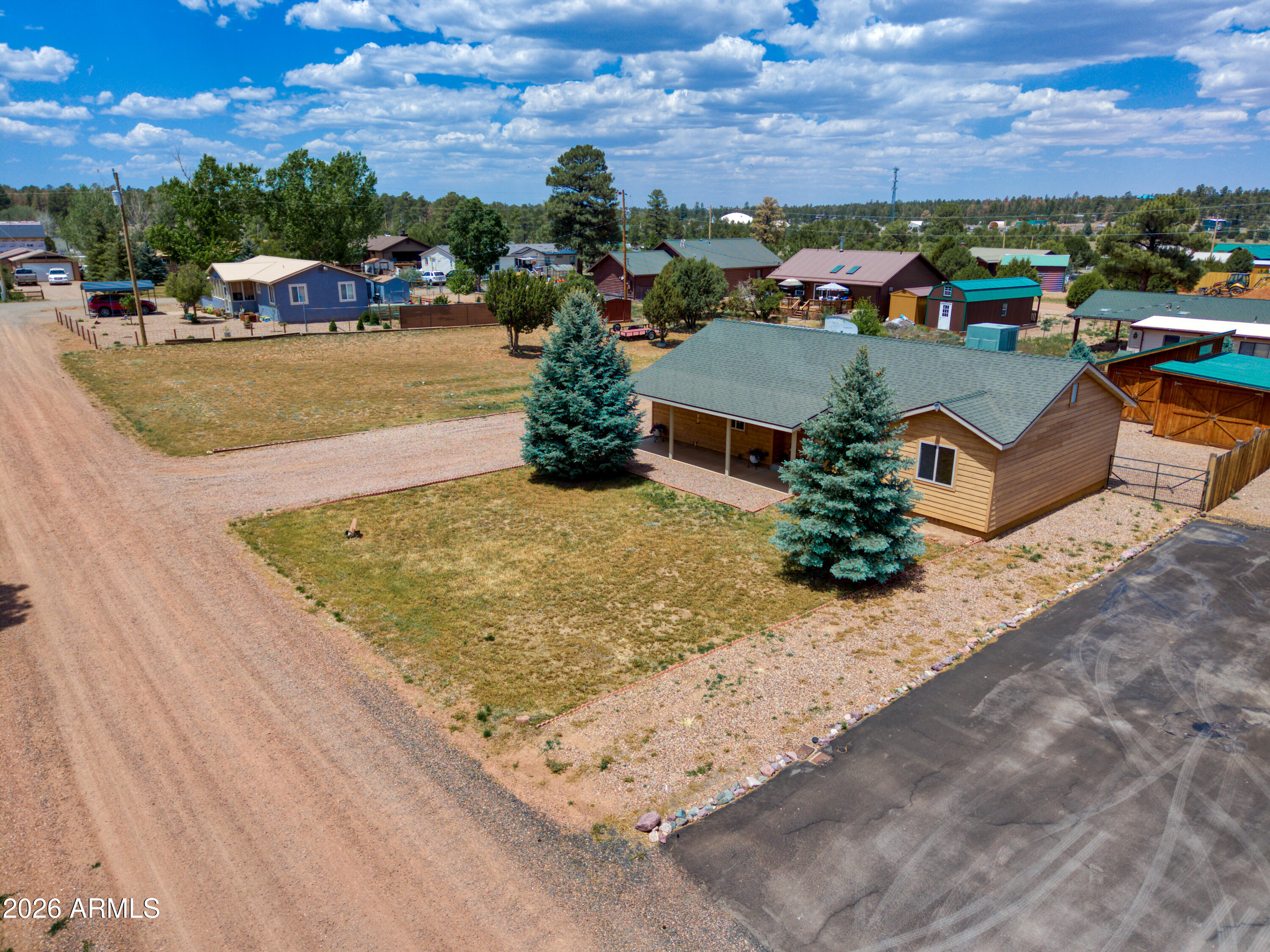 Welcome to your DOUBLE lot ranch-style single-level home, complete w/ lifetime wood siding! Beautiful new wood flooring a new cozy pellet stove, large windows.The kitchen is spacious, featuring a sitting bar, plenty of storage and cabinets walk in pantry.Master includes a unsuite and clear-story windows.Split floor plan includes 2 other bedrooms that share a full bath.The dining room offers a lovely view of the large, full-length back patio.Half of the property is fenced w/new wood posts,there are 2  RV gates. Charming Detached Barn garage with extra room for a bedroom or storage-240 Volt outlet. Double lot 1/2 acre.