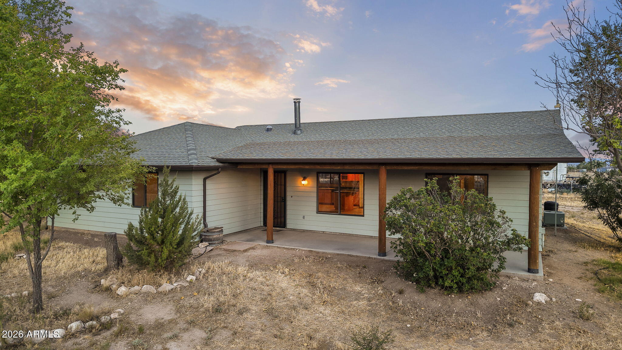 Experience the best of country living on this inviting 2.5-acre property, where open space, scenic views, and direct access to riding trails create the perfect setting for an equestrian lifestyle. Offering durable tile flooring throughout, quality insulation for year-round comfort, and a spacious 2-car garage. The well-equipped horse facilities include a barn with power and water, a stable, turnout area, and tack room, making it easy to care for your animals. Enjoy peaceful views overlooking neighboring 5-acre parcels and the nearby National Forest, just 1/4 mile away. New roofs on both the home (2020) and barn (2023), new window screens (2022), paved county-maintained access, rain harvesting, makes this property the ideal blend of comfort, functionality, and rural charm.