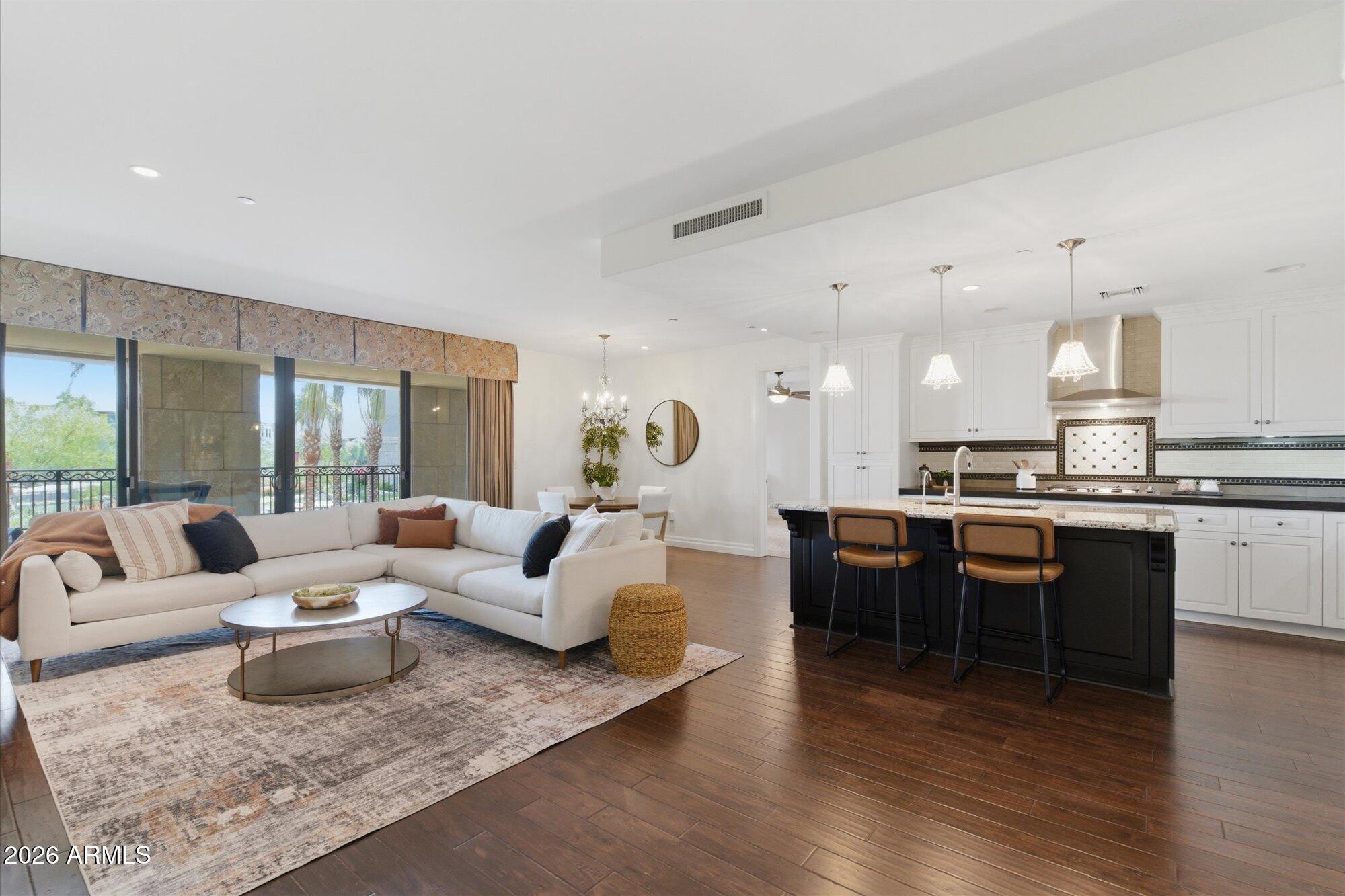 This is the one-bedroom that does not live like a one-bedroom. Spacious, beautifully remodeled, and full of smart flexibility, this Scottsdale Waterfront residence offers the feel and function of a much larger home -with a den/office that can be opened to the main living space, closed off for privacy, or easily converted into a second bedroom.Set above the fountain with serene courtyard and Waterfront and city views, this unit puts you right in the energy of Scottsdale - close enough to see it all, but just far enough away to feel private and relaxed. From the balcony, you can take in the movement, the lights, the water, and the lifestyle that make this building so special.Inside, the home has been thoughtfully updated with high-end wood flooring, and many other luxury finishes.