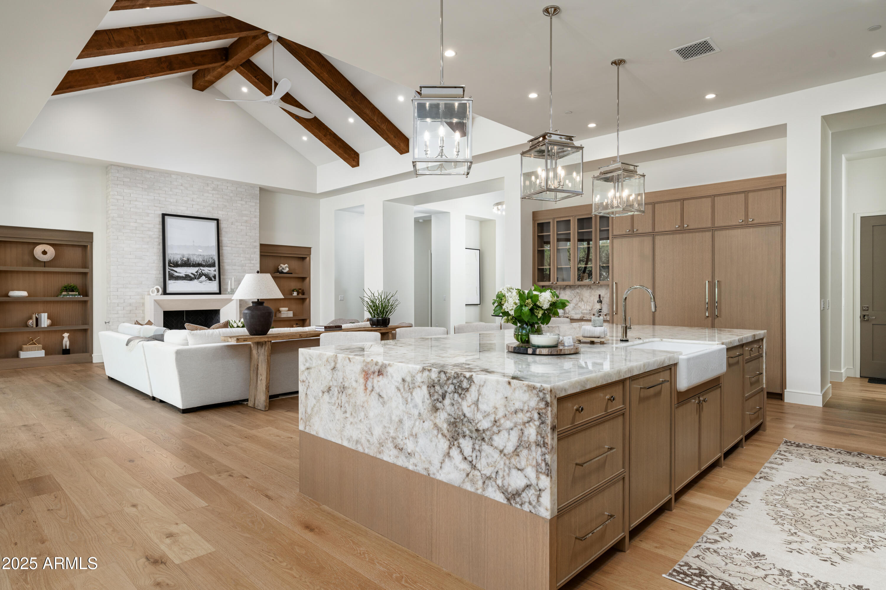 Brand new build located in one of Arcadia Proper's most desirable pockets, just minutes from Camelback Mountain, top dining, and the best of both Arcadia and Paradise Valley, this exceptional estate spans 5,673 sq ft on a premier half-acre lot. The home offers 5 bedrooms, 5.5 bathrooms, a private office, multiple flex spaces, a split floor plan, a finished basement, and a 4-car garage, designed for both elevated living and everyday ease. The 4,332 sq ft main level is anchored by a chef's kitchen that flows seamlessly into expansive living and dining areas, along with a dedicated office and versatile den. A 1,341 sq ft finished basement adds a game/bonus room, additional flex space for guests or a home gym, a powder room, and direct walk-out access to the backyard. The outdoor setting is equally compelling, featuring a pool and spa, built-in BBQ with bar seating, and an outdoor fireplace, perfect for entertaining year-round in one of Phoenix's most iconic neighborhoods.