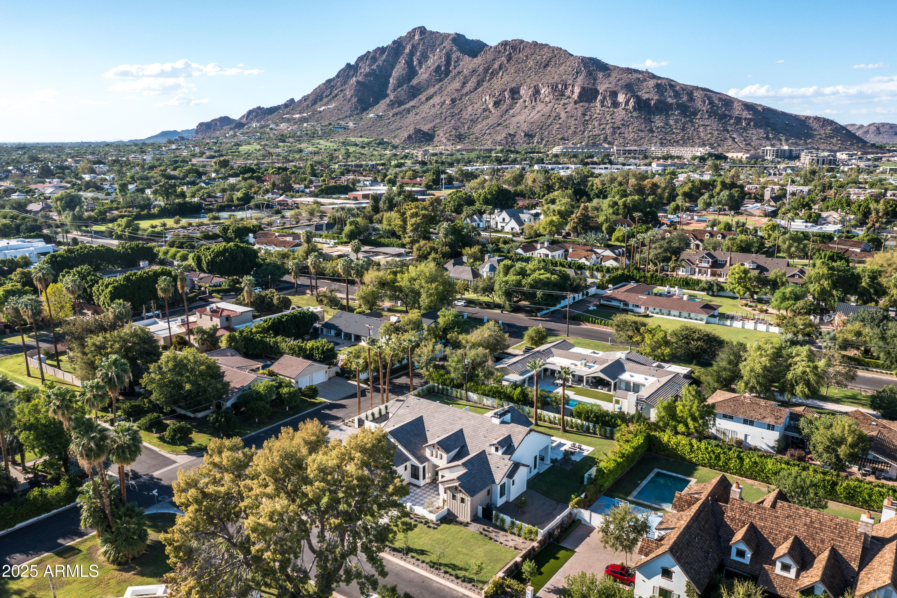 Brand new build located in one of Arcadia Proper's most desirable pockets, just minutes from Camelback Mountain, top dining, and the best of both Arcadia and Paradise Valley, this exceptional estate spans 5,673 sq ft on a premier half-acre lot. The home offers 5 bedrooms, 5.5 bathrooms, a private office, multiple flex spaces, a split floor plan, a finished basement, and a 4-car garage, designed for both elevated living and everyday ease. The 4,332 sq ft main level is anchored by a chef's kitchen that flows seamlessly into expansive living and dining areas, along with a dedicated office and versatile den. A 1,341 sq ft finished basement adds a game/bonus room, additional flex space for guests or a home gym, a powder room, and direct walk-out access to the backyard. The outdoor setting is equally compelling, featuring a pool and spa, built-in BBQ with bar seating, and an outdoor fireplace, perfect for entertaining year-round in one of Phoenix's most iconic neighborhoods.