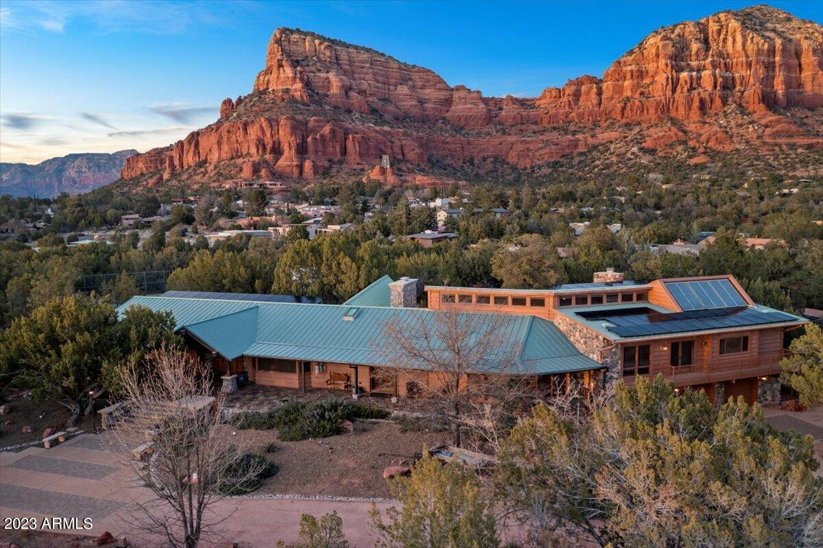 Welcome to your own private sanctuary! This 6+ acre estate, located in the famous red rocks of Sedona, is a lifetime opportunity to own an incomparable resort-style home and create memories that will last forever. With breathtaking majestic views from every corner, no HOAs or restrictions, and furniture available if desired - this property is ready for you!

The main house features an open concept living area with plenty of room for entertaining friends and family. The guest house provides additional space when needed while the detached shop offers ample storage or can be used as a hobbyist's dream. Enjoy outdoor activities year-round like playing a game of tennis on your court or lounging by the pool & spa featuring views of Chapel Holy Cross from the studio windows that are sure to inspire. And with its direct access to Coconino National Forest out back - there are endless possibilities in this rare & unique find!