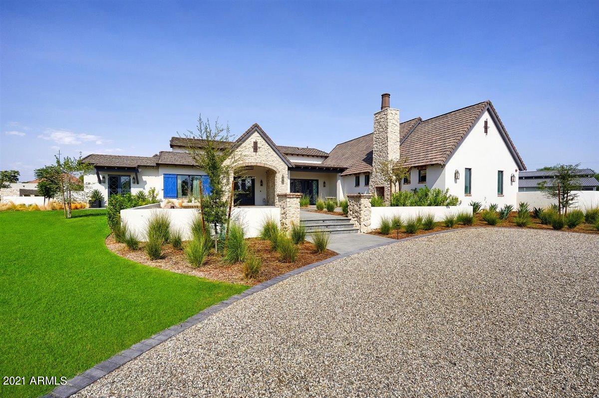 If you're looking for pristine new construction, love a unique modern farmhouse, and appreciate quality craftsmanship, design excellence and exquisite taste, your search has most likely just ended. Located in the highly coveted Bartlett Estates, this exceptional estate is all that and more. From the moment you arrive, you'll be taken with the timeless, yet fresh take on comfortable ranch living with individual custom touches at every turn. The gracious entrance leads to a dramatic great room accented with floor to ceiling stone, soaring ceilings, and an impressive walk-up wet bar. The island kitchen has every upgrade a seasoned chef would require, the home office has its own private entrance and will make working from home the preference, and after a long day of work, grab a workout in the full exercise room or a drink from the ultra-chic contemporary wine room. All the bedrooms and baths are finished with individual excellence including a master retreat that is nothing shy of a dream. Even the laundry room is notable. Natural sunlight fills every space and highlights the outstanding finishes, including stunning wide plank wood flooring, exposed 150-year-old Amish barn beams, impeccable millwork, sleek quartzite, quartz and marble surfaces, exceptional cabinetry, bold lighting, artistic tile accents, solid doors and windows, and top of the line fixtures. The detached guest house has a separate dedicated entrance and is finished with the same attention to detail, and to say the elaborate grounds are remarkable is an understatement. The sparkling pool, spa, water features, including two made of vintage horse troughs from Europe, lovely patios, pebble rock imported from California, a custom fireplace, and breathtaking mountain views combine to create an impeccable atmosphere, and the beauty doesn't stop there. There's a barn and riding arena for the horse lover in the family, and if that's not your passion, it's easily converted to a garage for the car lover or sport court for the athlete. This property is truly captivating and is sure to impress anyone looking for a fun family home perfect for the kids and grandparents alike!