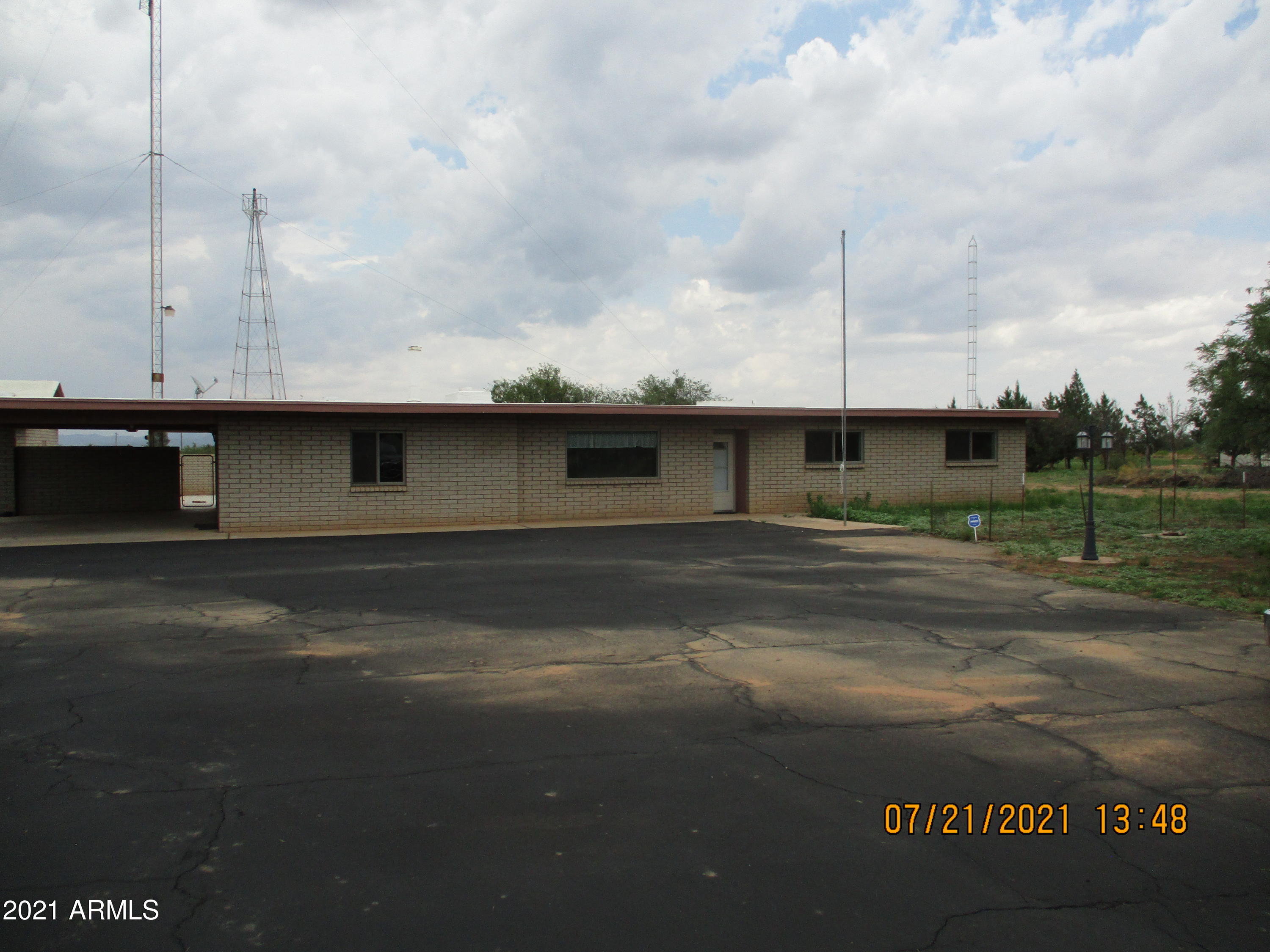 This property is on 4 acres fully fenced with beautiful views! Inside you will find 3 bedrooms and 2 baths with a large added family room and plenty of space to enjoy your family and friends. Large carport and a separate 2 car garage/workshop. Must see this home before it is GONE!