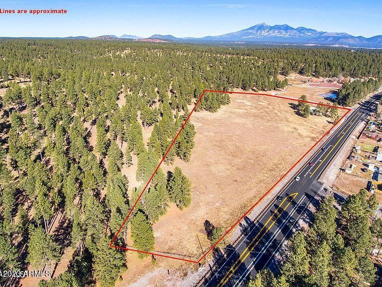 Gorgeous 14 acres Coconino County land adjoining 89A Highway. Close to Flagstaff city, Within 1 mile of I-17 &89A Intersection. Land perfect for multi-family, affordable housing and single family homes. Includes Cabin and sheds. It can be used for grazing and horses in summer and for snow play in Winter. Easy paved road access. Experience the best of Flagstaff luxury, NO HOA! This private mountain sanctuary is positioned  with panoramic forest views. Convenient proximity to downtown Flagstaff, 10 miles from Sedona, and easily accessible from I-17. Great for snow play!! Cabin equipped with heat/AC all appliances, separate laundry room. MUST SEE!!