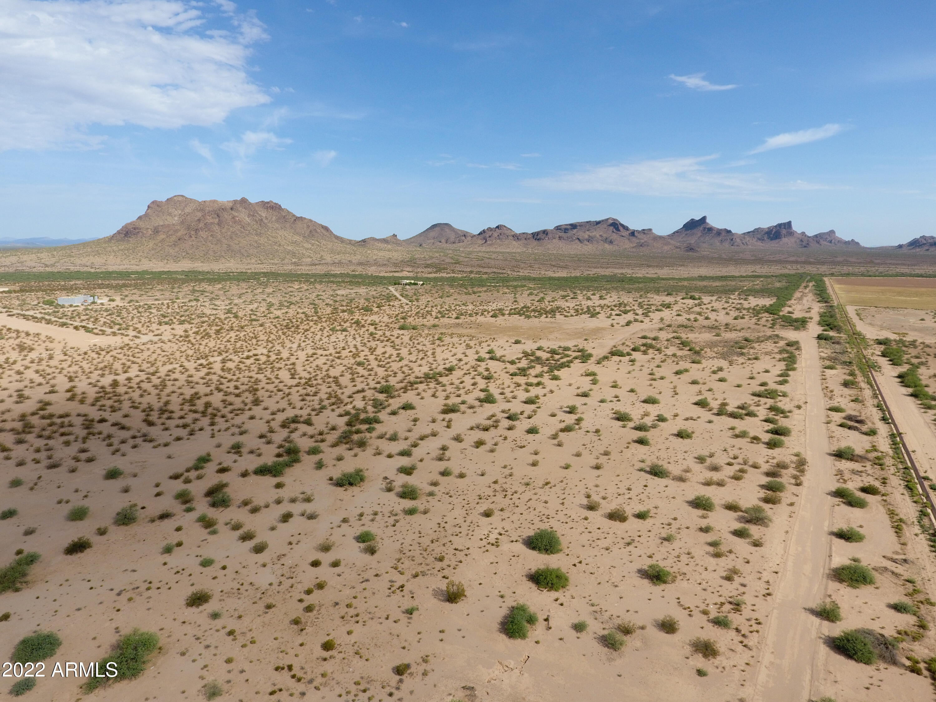 Farm and Desert Ranch for your consideration. Approximately 240 acres irrigated farm ground and 400 acres of desert ground. Located just over 20 miles from I-10 with access to Phoenix or Tucson.  Located across the street from the suburban ranchette community of Silverbell Estates. Endless opportunity with this piece. Take a look today. Includes 4 other parcels 409-01-003E,F,G,H