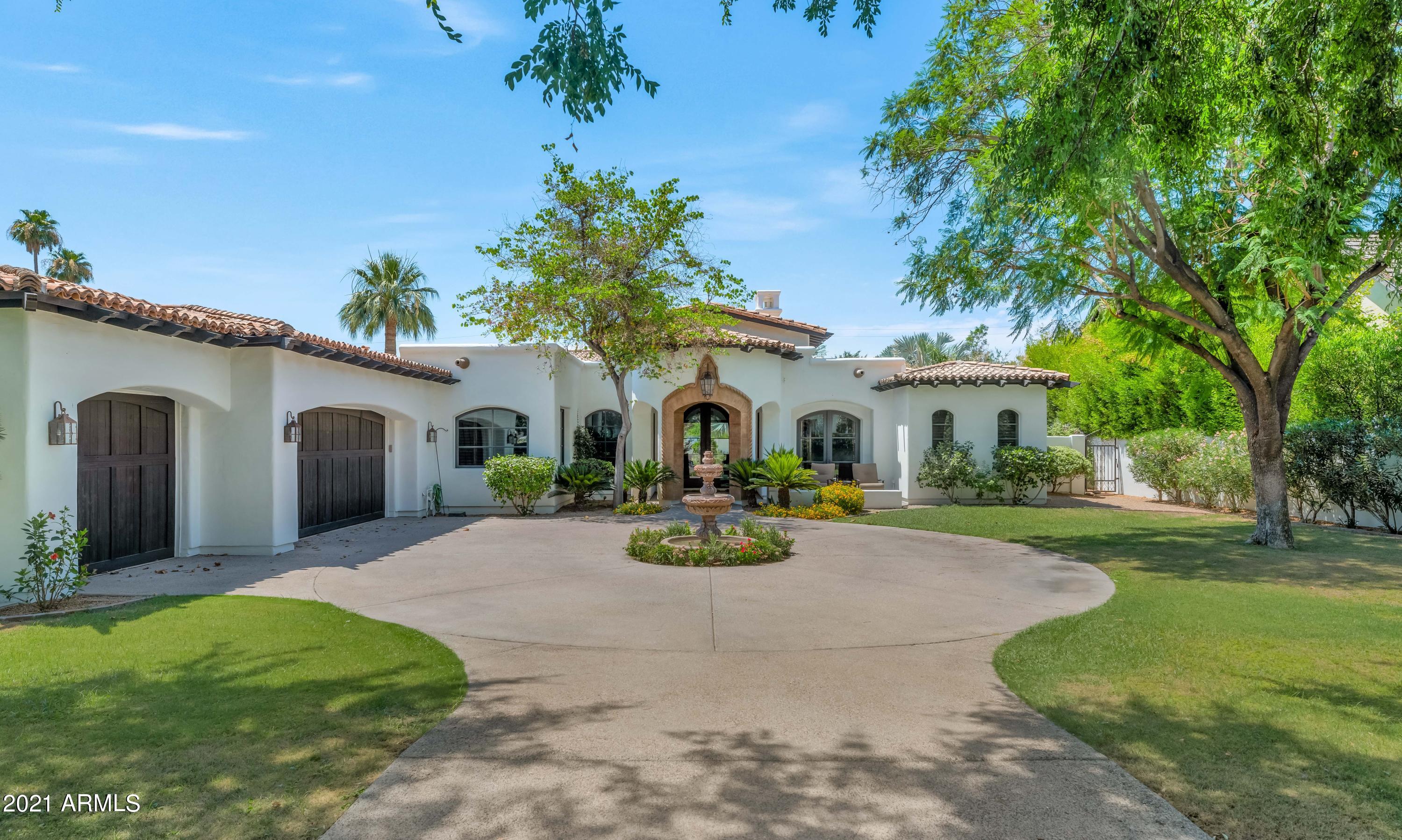 This stunning gated residence offers refined elegance and stylish comfort at every turn. From the moment you step inside the gracious foyer, you'll be struck by the impeccable quality and exceptional taste that fills each room. The spacious island kitchen includes top of the line Viking appliances, the great room exudes warmth, the living room is exquisite, family gatherings are easy to envision in the formal dining room, and unwinding after a long day in the master hideaway in front of a lovely fire is a treat. This home is built for entertaining with open spaces that not only flow seamlessly, but also perfectly capture the beauty of the home, both inside and out. Multiple custom stone fireplaces, dramatic lighting, impressive cabinetry, lovely bathrooms, and a full walk up wet bar are.. just a taste of the special features, and the huge covered patio, sparkling pool and spa with waterfalls, and putting green, create an outdoor environment every bit as special as the home itself. Located on one of the most coveted streets in Arizona, this gorgeous house is primed for the next lucky owner to call it home.