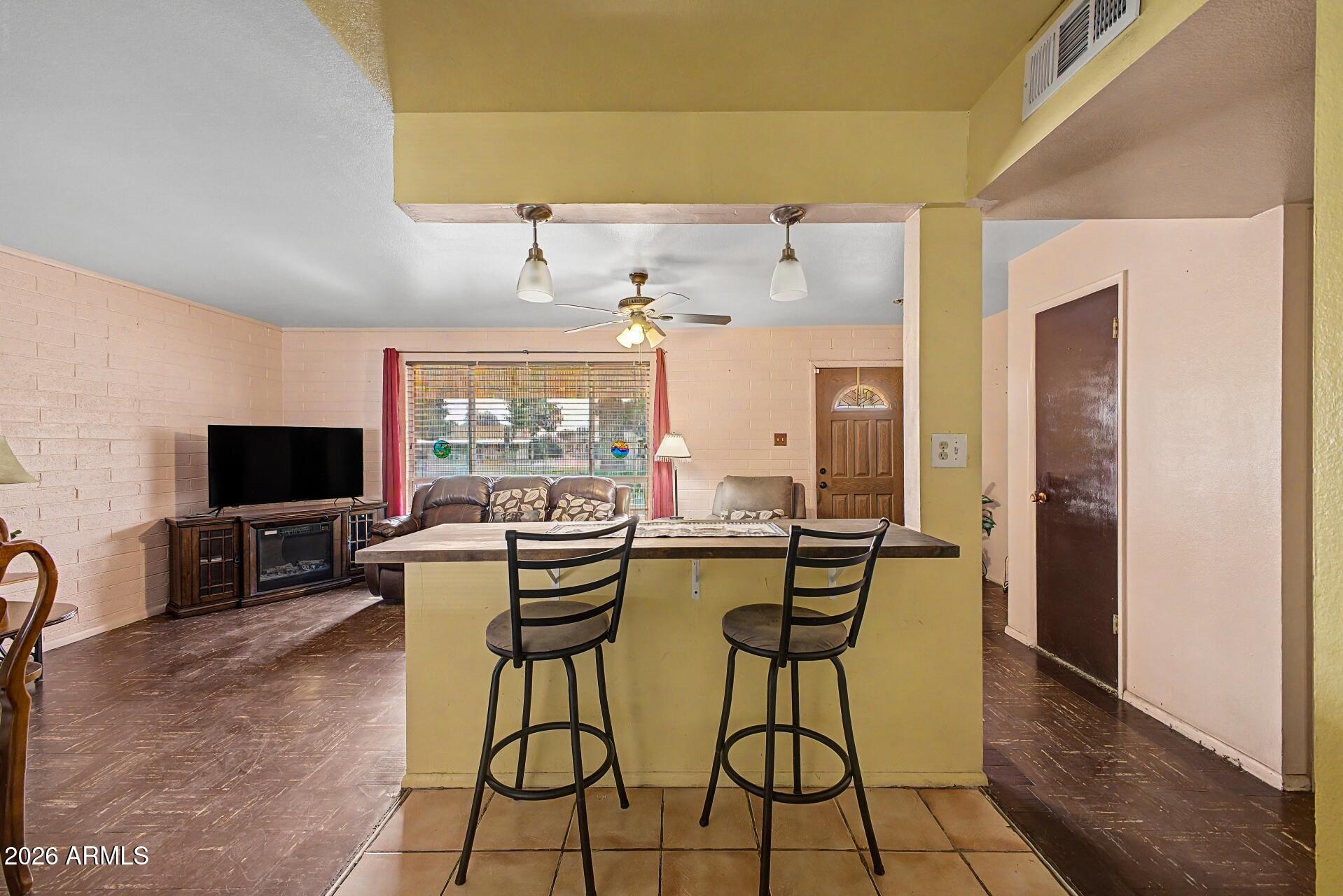 Charming Sun City home offering comfort, functionality, and incredible value. This 2-bedroom, 1-bath residence features 983 square feet of well-utilized living space on a spacious 7,000 sq ft lot.

Inside, you'll find an open layout with a gas cooktop, included refrigerator, and flexible dining spaces with both a breakfast bar and dining area. An Arizona room/lanai adds even more usable square footage - perfect for relaxing or entertaining year-round.

Exterior features include a covered carport, patio, storage space, and low-maintenance desert landscaping in both the front and back. Located in the highly sought-after Sun City community, residents enjoy access to exceptional amenities, including recreation centers, golf courses, and an active lifestyle environment.