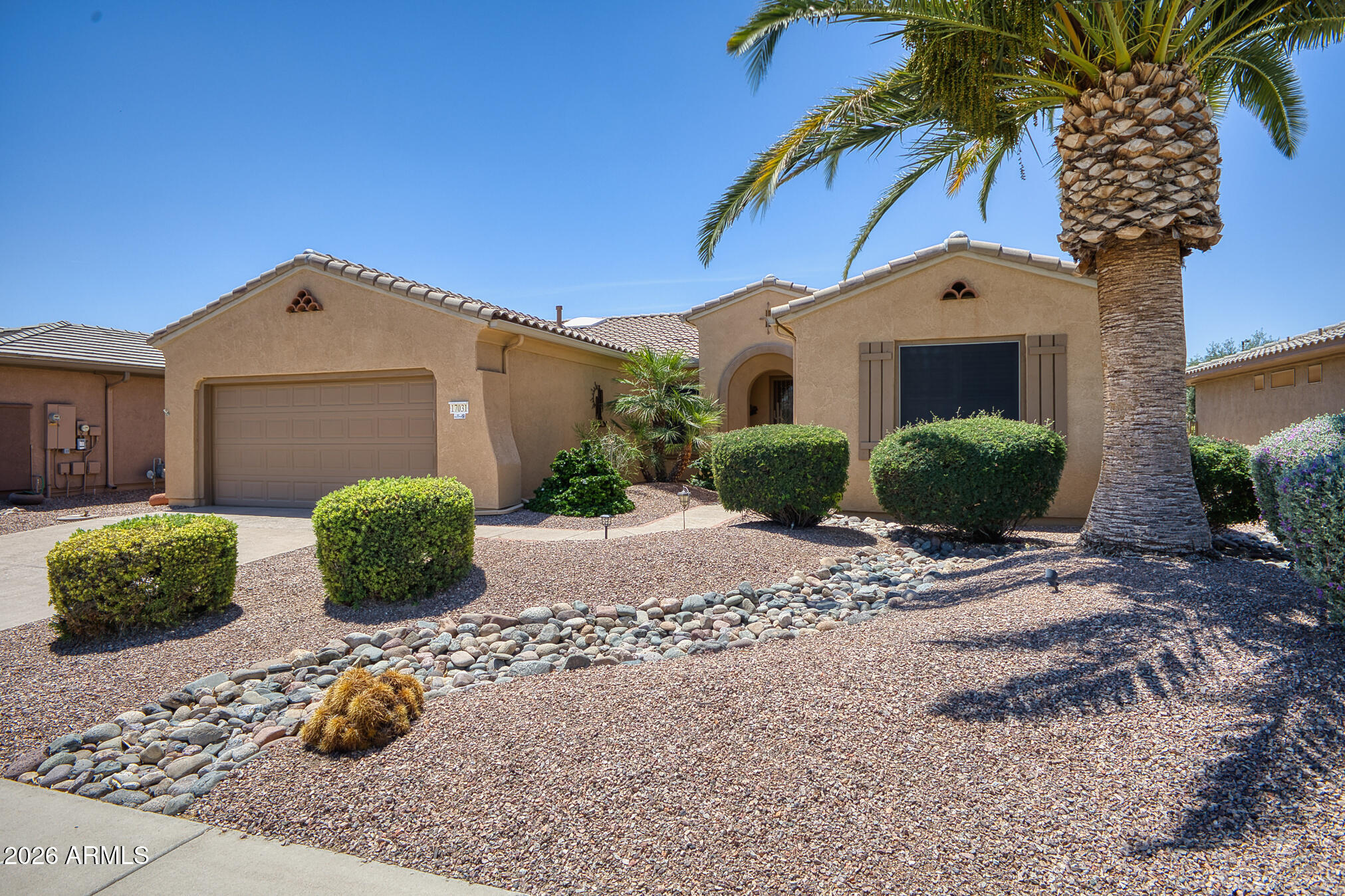 Experience the sought-after lifestyle of Sun City Grand in this beautifully maintained Mission floor plan offering 3 bedrooms, 2.5 baths &  exceptional indoor-outdoor living. Designed for both everyday comfort and entertaining, the spacious great room showcases a custom media wall. The gourmet kitchen features gorgeous granite countertops, BIG Island stainless appliances, skylights, breakfast bar & a sunny breakfast nook overlooking the backyard. Step outside to the desirable south-facing extended covered patio complete with a pergola & outdoor kitchen perfect for relaxing or hosting family & friends year-round. The private primary suite offers direct patio access with a security door, dual vanity sinks, & a spacious walk-in closet. OWNED Solar - no solar payment!  2026 Roof, AC replaced Bedrooms 2 & 3 have a private bath. Laundry is inside. Powder room is located off the kitchen excellent for overall privacy. Plantation shutters throughout. This move-in ready home combines comfort, quality, and the resort-style amenities that make Sun City Grand one of Arizona's premier active adult communities. Come see this exceptional home today!