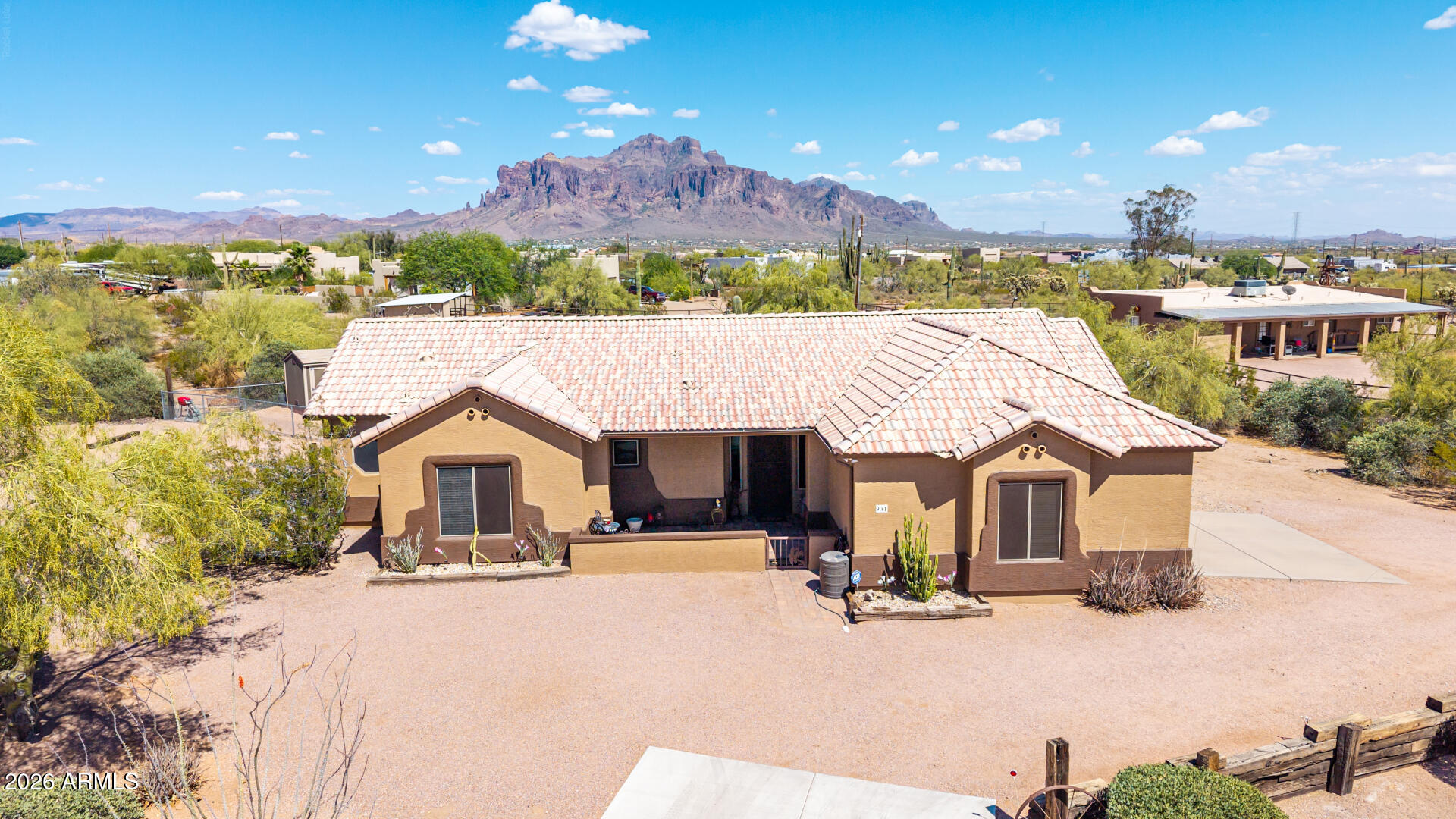 Perfectly positioned on a sprawling 1.25-acre equestrian property in Apache Junction with panoramic views of the Superstition Mountains! Designed for the true Arizona horse & outdoor adventure lifestyle, this rare property offers direct access to nearby horse trails right from your property with plenty of room for horses, trailers, toys, RVs, and more. Equestrian features include 3 horse stalls, a round pen, tack shed, Tuff Shed, dog kennel, and wide-open usable land ready for riding, training, and enjoying the desert lifestyle. Whether you're an avid rider, roper, trail enthusiast, or simply looking for space and freedom, this setup delivers the functionality and convenience horse owners seek. Inside, embrace modern charm & elegance with an impressive open floor plan bathed in natural lig ght, creating the perfect setting for comfortable living & effortless entertaining. Well-appointed kitchen offers SS appliances, ample cabinetry, a mosaic tile backsplash, granite counters, an island w/a breakfast bar, & recessed lighting. Romantic main retreat boasts a bay window, an ensuite with a jetted tub, & a walk-in closet. Tranquility awaits in the serene backyard complete w/a covered patio, spa, built-in BBQ, storage space, endless mountain views, and unforgettable Arizona sunsets. Rare opportunity to own a horse property with direct trail access, breathtaking scenery, and the ideal blend of equestrian living and outdoor adventure!