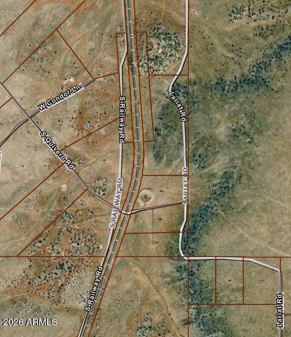 Incredible 14.88-acre parcel offering endless possibilities in a peaceful rural setting. This unique property borders State Land and the Grand Canyon Railway, creating a scenic backdrop with added privacy. A natural cattle pond attracts abundant wildlife, making it ideal for nature lovers and outdoor enthusiasts. Located less than one mile off Highway 64, the property is accessed by a gated gravel road maintained by the HOA. Centrally positioned approximately 25 minutes from the Grand Canyon entrance and about 30 minutes from downtown Williams, this parcel combines convenience with tranquility. A recent perc test confirms eligibility for a standard septic system, making it ready for your future build.