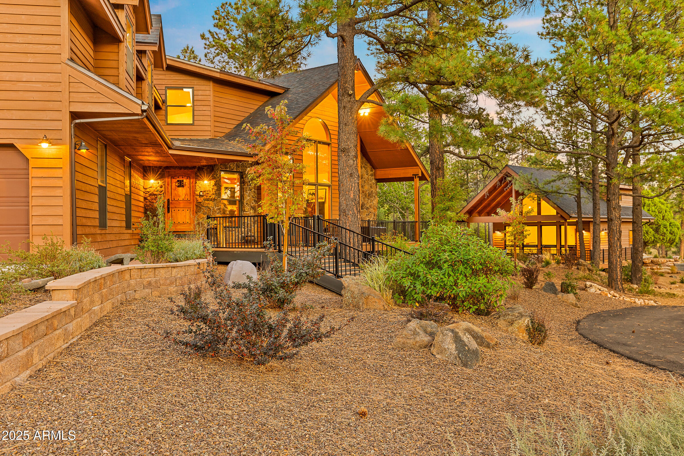 Welcome to an unparalleled 5 acre sanctuary nestled within the Flagstaff city limits, surrounded by the breathtaking beauty of the Coconino National Forest. This rare find offers the perfect blend of privacy and convenience—just two miles from the Continental Country Club and free from HOA restrictions. At the heart of this property is a completely remodeled main residence, spanning 4,106 square feet—a true masterpiece of design and craftsmanship. This 3-bedroom, 3-bath home features laundry on both levels and showcases high-end finishes throughout. The spacious open floor plan is adorned with custom-built alder cabinets, knotty alder doors, and striking granite countertops. Enjoy movie nights in your private theater room with surround sound, or retreat to the luxurious primary suite, complete with an attached home office and a private balcony overlooking the National Forest perfect for soaking in the views from the relaxing hot tub. The gourmet kitchen is a chef's dream, boasting stainless steel Monogram appliances, stunning tile accents, and a custom dining island. Entertaining is effortless with a full bar, built-in refrigerated wine storage, and commercial ice maker. Step outside to an entertainer's paradise, where a stone kitchen awaits complete with a pizza oven, Napoleon BBQ grill, and expansive custom decks designed for hosting unforgettable gatherings. Guests will feel pampered as soon as they step foot in the newly completed 998 sq. ft. guest house, built with the same meticulous craftsmanship of the main residence. Featuring 2 bedrooms and 2 bathrooms, it offers a private retreat for family and friends. Car enthusiasts and hobbyists will love the impressive 2,024 square foot garage, equipped with RV doors, Guardian epoxy floors, and interior hookups ideal for heavy equipment storage, a workshop, or a personal (wo)man cave. A detached 12' x 24' flex space offers even more possibilities, whether for additional storage, a home gym, or an office. With a total of 5 bedrooms and 5 baths, this magnificent home is designed for both intimate living and grand gatherings. Wildlife lovers will appreciate the frequent visits from elk and deer, while outdoor enthusiasts can take advantage of nearby National Forest trails just steps away. Modern amenities make this property as practical as it is luxurious, with city water service, a backup water system, APS & a back up generator, propane, and two certified septic systems. Designed by premier architect Anne Mead and fully permitted by the city, this home is move-in ready and offered fully furnished (some personal items excluded). This legacy property is truly one-of-a-kind, offering peace, privacy, and luxury in an exclusive setting. Don't miss your chance to own this spectacular retreat. Book a private tour today and begin your journey to unparalleled mountain living! Seller is a licensed Real Estate Broker in Arizona.