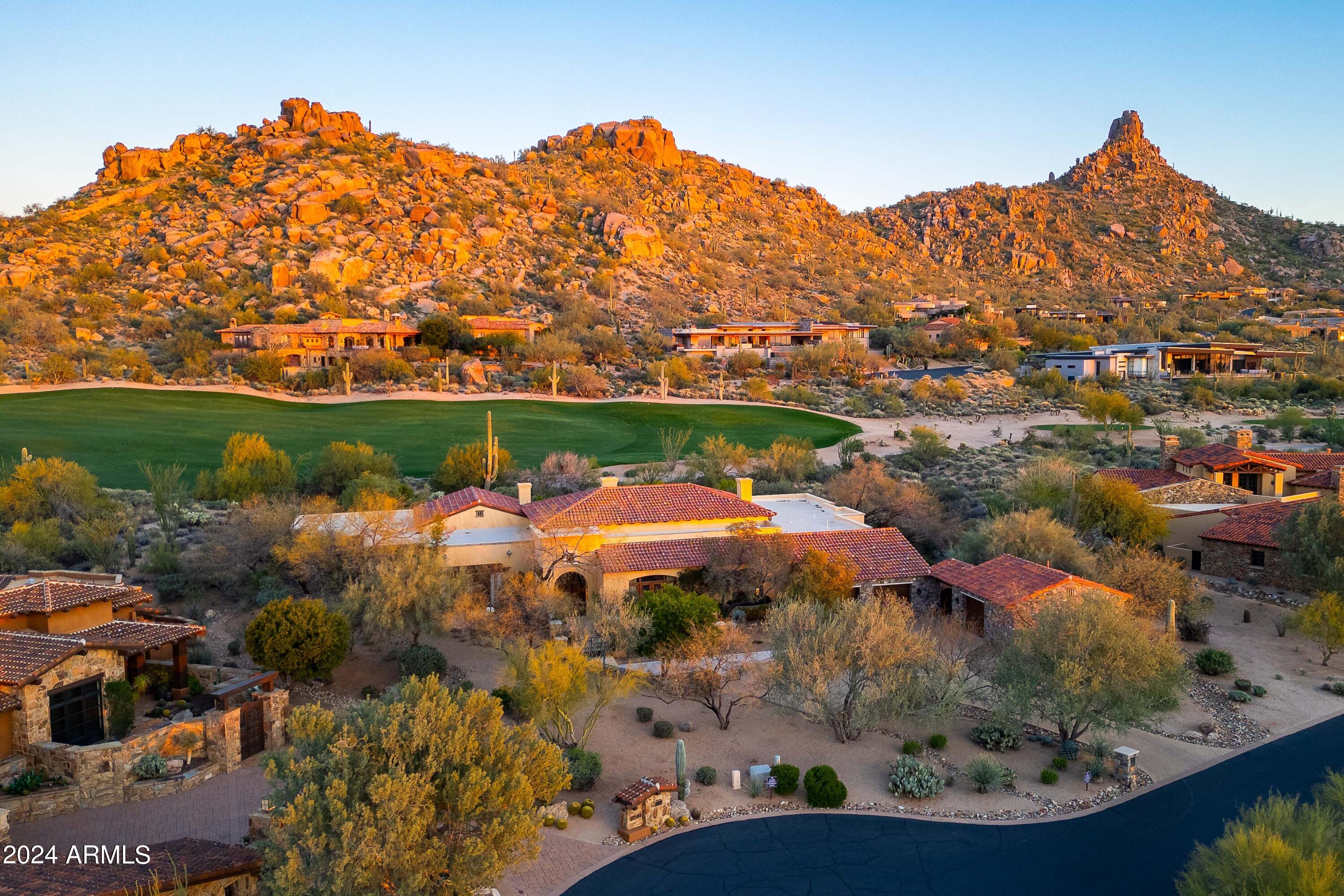 Step into this exquisite Estancia residence and embark on a journey reminiscent of a European countryside with each room a tribute to the allure of Italy, France, Scotland, and the sophistication of London. Nestled within the esteemed Estancia community, this timeless estate boasts enduring architecture and design, providing a haven of opulence overlooking the ninth hole of the renowned Estancia golf course. With sweeping views of Pinnacle Peak Mountain greeting you upon arrival, the meticulous thought and passion poured into every detail of this awe-inspiring estate is an elegant statement. Bask in the Arizona sun by the pool, surrounded by lush foliage reminiscent of an Italian villa, enjoy a peaceful interlude on one of the numerous private patios located off entertaining spaces, bedroom suites, and the main living area or intimate gatherings by the outdoor fireplace as the sun sets behind Pinnacle Peak Mountain, setting the stage for evenings filled with wonder and beauty.  This extraordinary estate will transport you to a European retreat.  Property shown upon private request.