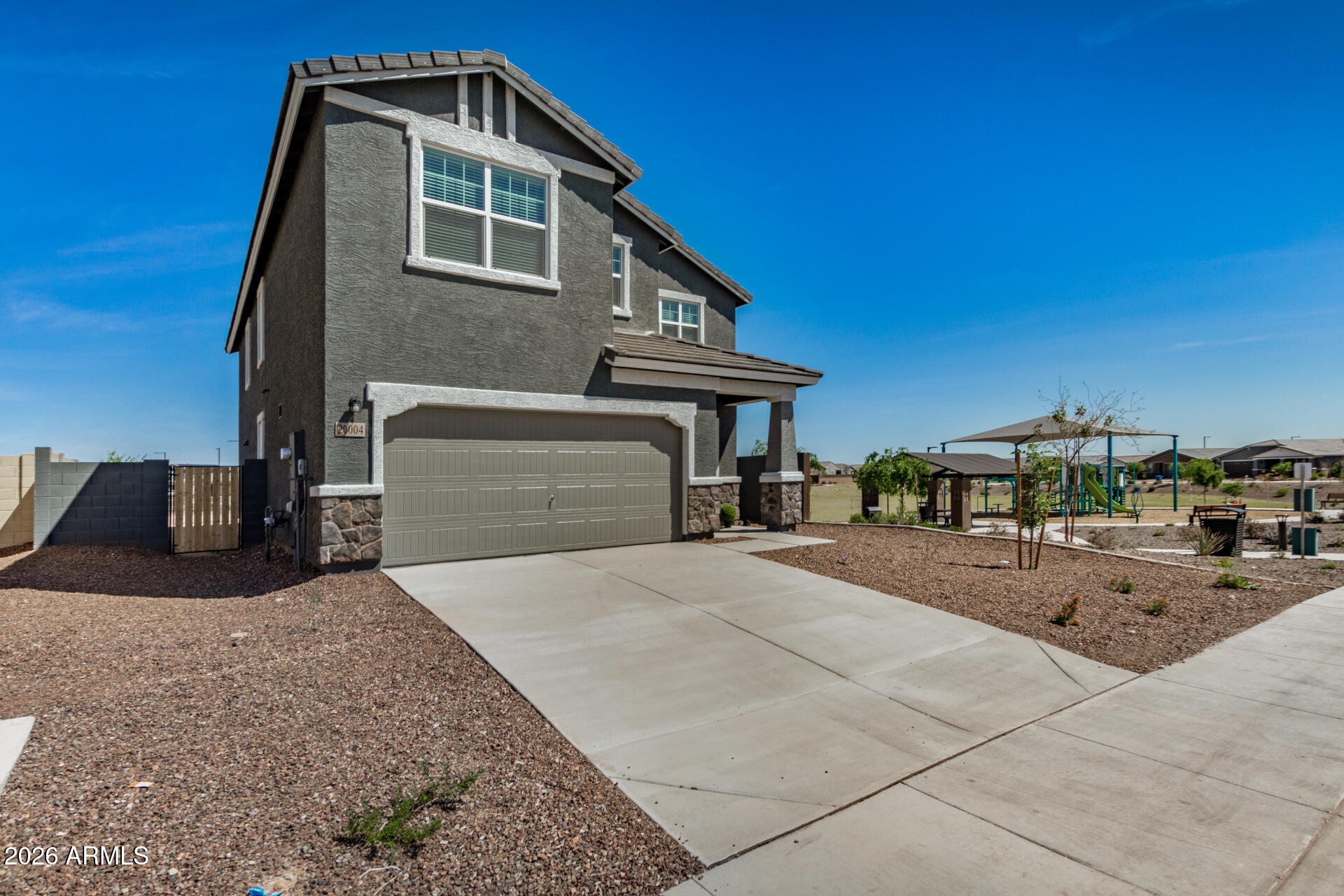 Move-in ready 5 bed 4.5 bath West Valley location. Prime Corner Lot next to Park!  North South exposure Featuring countless upgrades such as 9' ceilings, , Granite countertops in the kitchen. Whirlpool Stainless steel appliances including the refrigerator. White Shaker cabinets. Energy-efficient features throughout, programmable thermostat, gas water heater, gas range, Whirlpool washer & dryer. Front yard landscaping, covered patio in the backyard. Peak-a-boo Mountain Views! Minutes from Verrado in a master-planned community featuring walking trails, greenbelts, neighborhood park with playground, soccer field, and volleyball court. Conveniently located near the I-10 and 303, schools, shopping