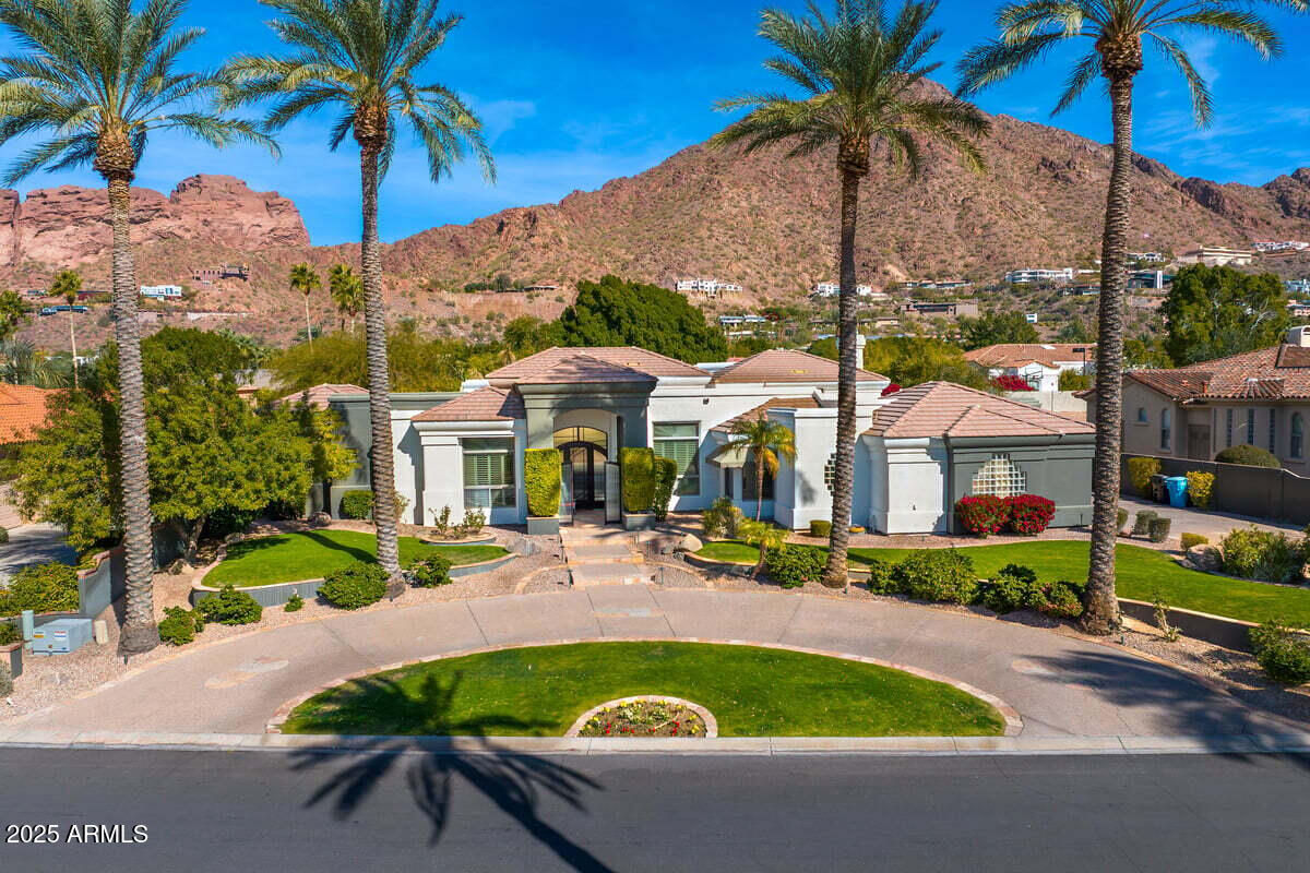Stunning custom home with Prime Arcadia location! Walking distance to Royal Palms, The Village Health Club, AJ's, The Amabassador and numerous restaurants. Take in breathtaking views of Camelback Mountain from every room. This custom home has marvelous indoor & outdoor spaces and a single-level, split floorpan, with countless amenities. High ceilings, gas fireplaces, 2 dishwashers, gas range, designer light fixtures, hard wood floors, enormous walk-in closet, art niches with accent lighting, & large windows to enjoy the view. Huge pocket doors are a perfect transition to the outdoor living ideal for entertaining. Lush landscaping, cascading waterfall, hot tube, fire pit, BBQ and more.Minutes from downtown Phoenix, Biltmore, Sky Harbor Int'l Airport,Fashion Square, golf, hiking & Old Town.