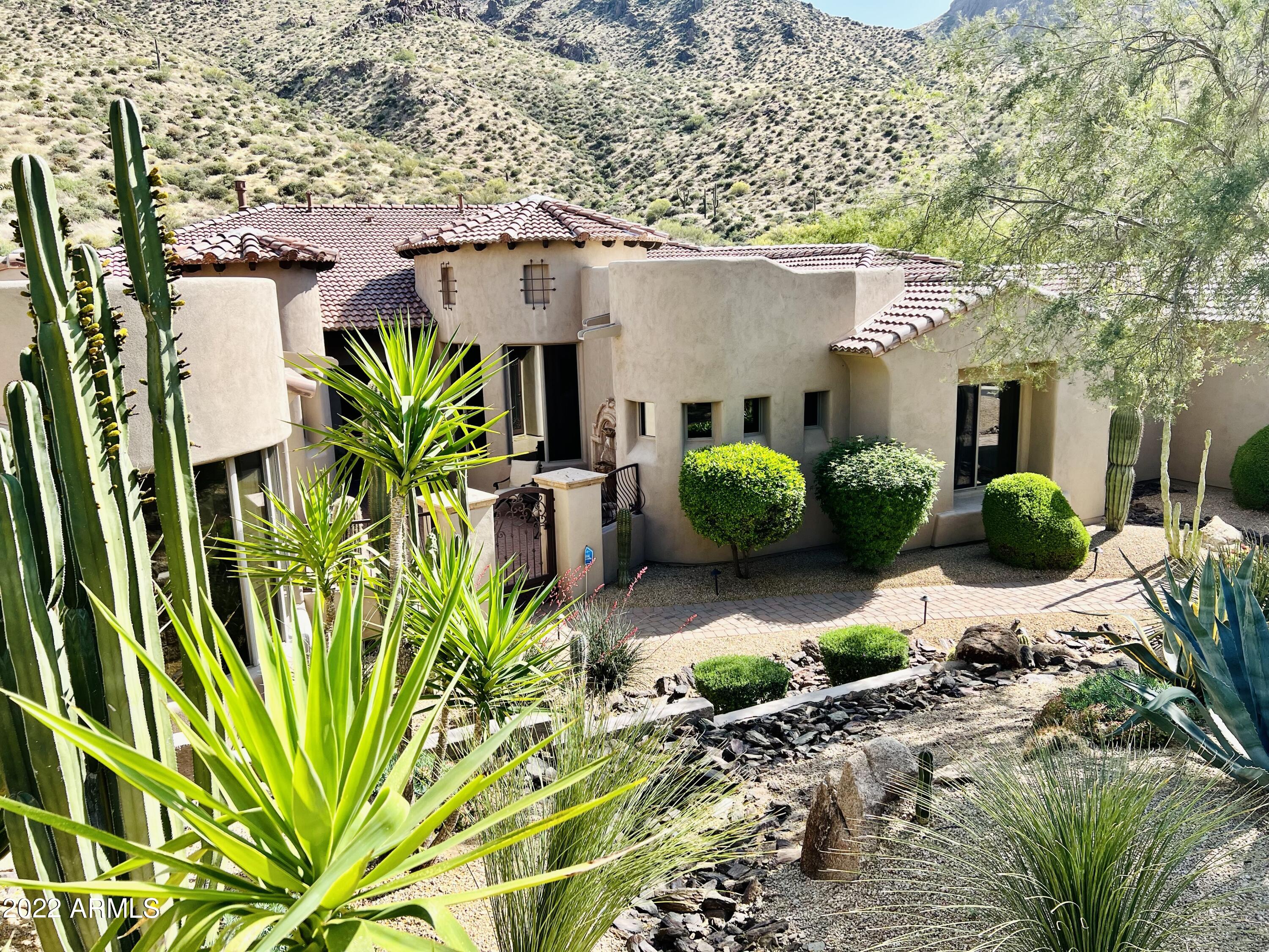 PRIVATE & TRANQUIL. Lock & Leave Resort Style Living! Nestled within the gated community of TROON HIGHLANDS ESTATES. This beautifully designed smart home has it all, featuring breathtaking views of the mountains while relaxing & witnessing the marvels of the sunrise & sunset from the back patio. 4 bedrooms, 4.5 bath, large home office & a spacious Casita. 3-Car Garage. Featuring Control4, New Roof, New AC in Casita & Dog Run. The backdrop of this breathtaking estate is the natural beauty of the McDowell Mountains. The spa sits atop the backyard while the waterfall streams down into Infinity edged heated pool w/ a swim-up bar & built-in BBQ. In the evening, relax by the natural gas fireplace or fire pit, sip a cocktail and watch the sun set. NO INTERIOR STEPS. Loaded w/ upgrades & features. ***FEATURES/UPGRADES***
See the DOCUMENTS TAB for the Expanded Features & Upgrades List
Private Gated Community of Troon Highlands Estates.
TRANQUIL, QUIET & PRIVATE ESTATE & BACKYARD
Custom Build by LUXOR.
LOW HOA FEE.
Built for Entertaining & Privacy //  Lock & Leave Resort Living! 
Own 1.9 acres on the Edge of the McDowell Mountain Preserve Nestled against the Hillside. Surrounded by Panoramic Mountain Views.
Elevated Modern Tuscan design with an Open Floor Plan.
Incredible Sound System throughout the home including the outdoor patio.
Saltwater Infinity-Edge Heated Pool/Spa, with Swim-up Bar, controlled by AquaLink.
Water & Fire Features - around the pool & spa
PRIMARY OWNERS SUITE; features mountain views, remote-controlled curtains in the sitting area, spacious en suite with shower for two, soaking tub, extra-large walk-in closet. 
Each Bedroom Suite has its own En Suite.
LIGHT & BRIGHT OPEN FLOOR PLAN
Plenty of Entertainment Spaces
Property Backs to the Mountains
Motorized Shades & Curtains w/remotes
Neighborhood adjoins Tom Thumb with Access to Trails
Spacious Indoor / Outdoor for Entertaining 
LARGE OPEN KITCHEN - Stainless Steel Appliances; Wolf Gas Range, Wolf Double Wall Ovens & Warming Drawer, Professional KitchenAid Side-by-Side, Wolf Built-in Microwave, Miele Built-in Coffee Maker, RO Water System and NEW Bosch Dishwasher & features an Extra-Large Island / Kitchen & Wet Bar - Open to the Great Room
LARGE CASITA w/ En Suite, Separate Entrance 
BEAUTIFULLY LANDSCAPED - low water usage & maintenance
NEW Concrete Tile Roof (all tile is new), March 2022
NEW Bosch Stainless Steel Dishwasher, April 2021
NEW HVAC unit for Casita, installed Feb 2022 
NEW Gated Dog Run with Astro-Turf, April 2021
SWIM UP BAR with NEW Custom Metal Railing, April 2021
NEW Outdoor Landscape Lighting in Front Yard, Oct 2021
NEW Drip Irrigation System - Entire Landscaping, Oct 2021
Ring Door Bell & New Ring Garage/Drive Camera.
Large Home Office; or re-purpose as a Home Gym or 5th Bedroom.
Spacious Owners' Suite with Views of the Mountains.
Large Walk-In Pantry with added storage.
Wet Bar & Wine Cooler - made for Entertaining.
No Interior Steps - 1 small step-up for showers.
SMART HOME FEATURES; Control4 Smart Home System // AquaLink Smart Pool System // RING Doorbell/Camera & New Garage/Driveway Camera.
HVAC SYSTEM: Main House; 2 Lenox HVAC Systems - 2018 // Casita NEW - 2022
2 Gas Fireplaces, Fire Pit & Fire Features around Pool & BBQ.
Heated Pool & Spa with Water & Fire Features
Minutes to Hiking/Biking Trails, Shopping & Fine Dining
Move in Ready!!! ...Welcome Home!
**All Furniture & Furnishings  negotiable.
