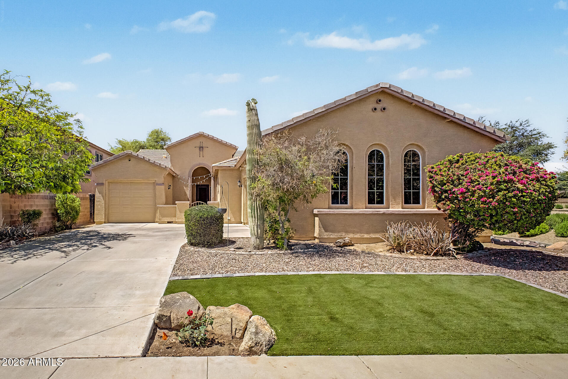 First impressions matter, and this home delivers. Situated on a corner lot in a quiet cul-de-sac, you're welcomed by a private gated courtyard that sets the tone for the rest of the property. Located just steps from Chandler's Centennial Park--with green space visible from the backyard--you'll enjoy a setting that blends privacy with convenient access to outdoor recreation, top-rated Chandler schools, shopping, dining, and more. Inside, this four-bedroom, two-and-a-half-bath home features a bright, open-concept layout with 10-foot ceilings that enhance the sense of space. The kitchen is designed for both everyday living and entertaining, offering modern stainless steel appliances, a gas range, and a large island with counter-height seating. The spacious primary suite is thoughtfully positioned and includes a private ensuite bath with dual vanities, a separate tub and shower, and a large walk-in closet. A split floorplan provides privacy, with three secondary bedrooms located on the opposite side of the home. Near the front entry, a flexible den can function as an office, additional living space, or fifth bedroom. There's also ample storage cabinets in the garage and laundry. The backyard offers a comfortable outdoor retreat with a grassy area, flagstone patio, and raised garden beds ready for your green thumb. Recent updates include AC (Feb 2021), water heater (Oct 2024), refrigerator (July 2023), and dishwasher (Jan 2022).