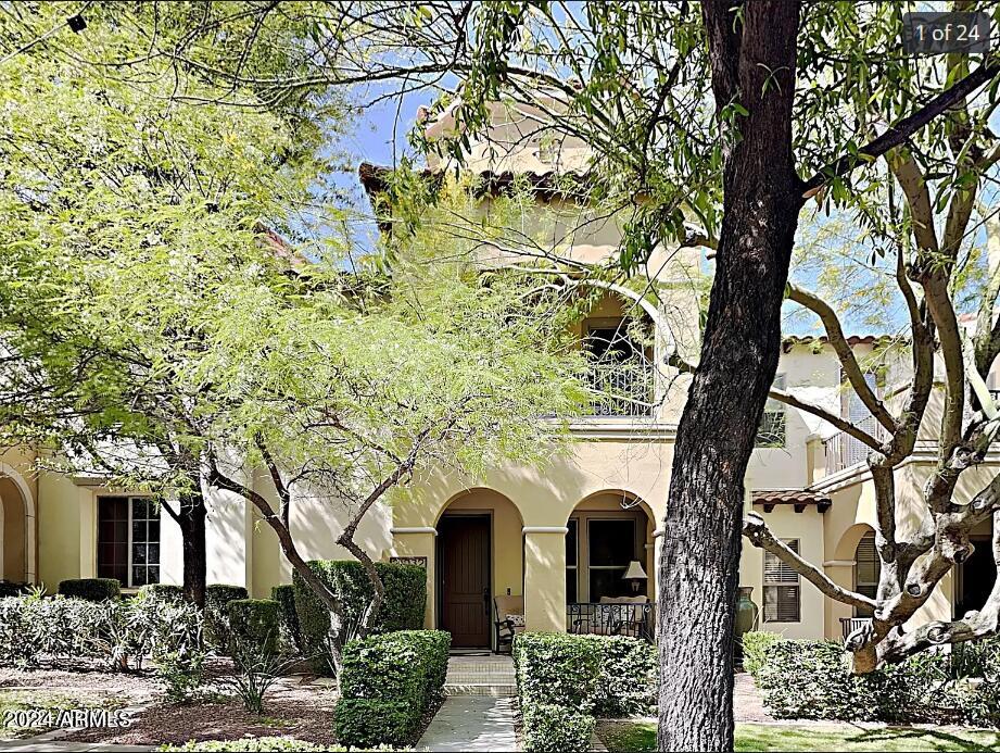 Prime Location! This was once the model home, boasting all the desired upgrades you could imagine. Featuring luxurious granite countertops, top-tier flooring, and premium cabinets throughout. Enjoy a charming balcony with picturesque views of the town square. Just a stone's throw away, you'll find the community pool, fitness center, grocery store, shopping, restaurants and entertainment. Test your skills on one of Verrado's 2 championship golf courses! Verrado is located in an 'A' rated Litchfield School district with both elementary and middle schools just a block away. Entertain effortlessly with the built-in BBQ and cozy fireplace  garage access conveniently located at the rear of the home, this property is an absolute must-see!