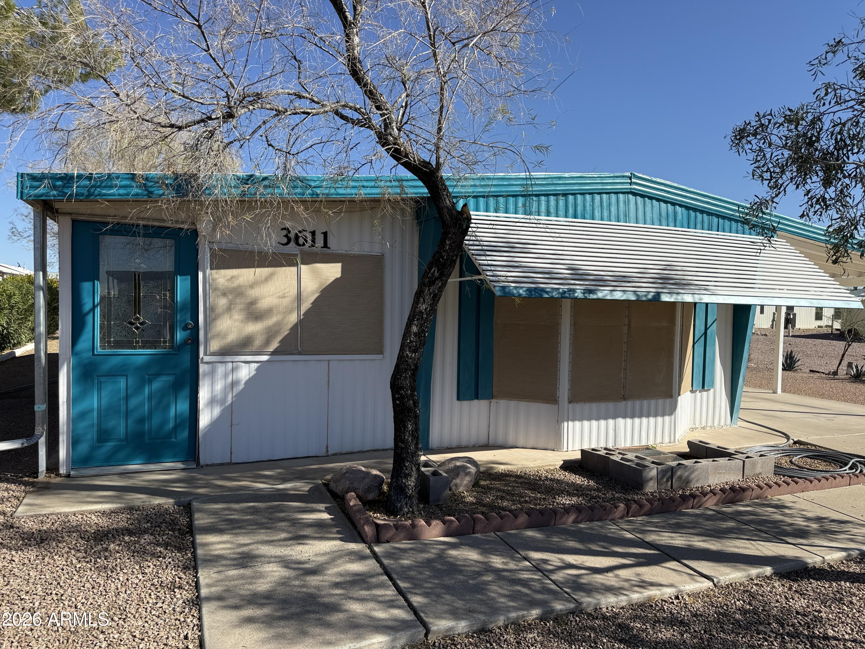 This is a 2 bedroom, 2 bath home that has an Arizona room, possibly as much as 300 sg ft of additional living space.  (not added into the square footage) for nice area to entertain or hobby room.  New wood laminate flooring in the living room,.  New tile tub and shower in the primary bedroom.  New carpeting in the Primary Bedroom.  New Birchwood paneling in the primary bedroom.  Both Bathrooms are fully remodel.  Built in China hutch in living room.  The Arizona Room has a new roof, as well as a large portion of the main house done in January 2026.  This is a cute lot and a wonderful subdivision where you own the land, low HOA fees for lots of fun activities: golf, heated pools, spas, pickle ball courts, horseshoes, billiards hall, clubhouse with craft rooms, exercise area and Library.