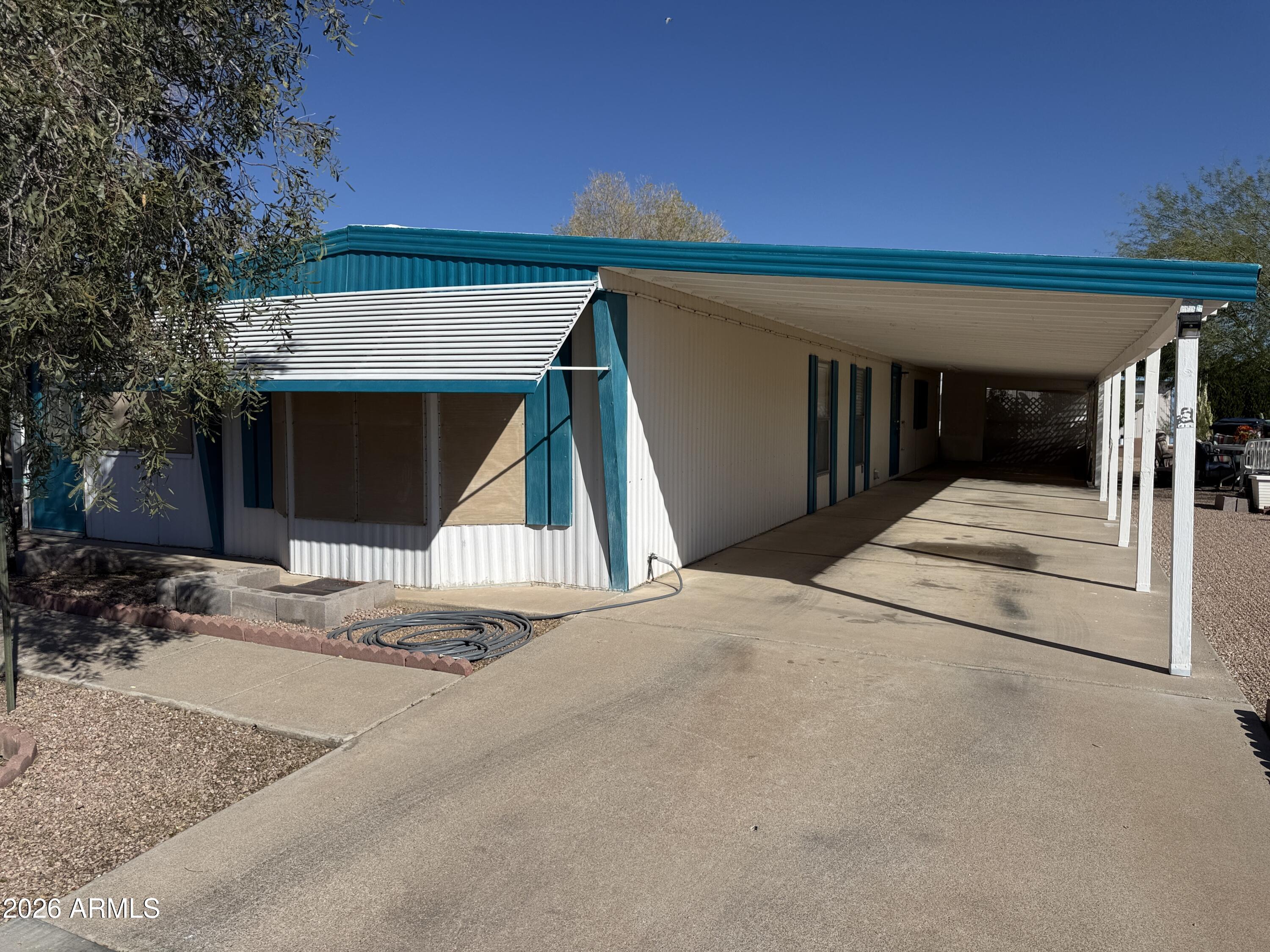 This is a 2 bedroom, 2 bath home that has an Arizona room, possibly as much as 300 sg ft of additional living space.  (not added into the square footage) for nice area to entertain or hobby room.  New wood laminate flooring in the living room,.  New tile tub and shower in the primary bedroom.  New carpeting in the Primary Bedroom.  New Birchwood paneling in the primary bedroom.  Both Bathrooms are fully remodel.  Built in China hutch in living room.  The Arizona Room has a new roof, as well as a large portion of the main house done in January 2026.  This is a cute lot and a wonderful subdivision where you own the land, low HOA fees for lots of fun activities: golf, heated pools, spas, pickle ball courts, horseshoes, billiards hall, clubhouse with craft rooms, exercise area and Library.