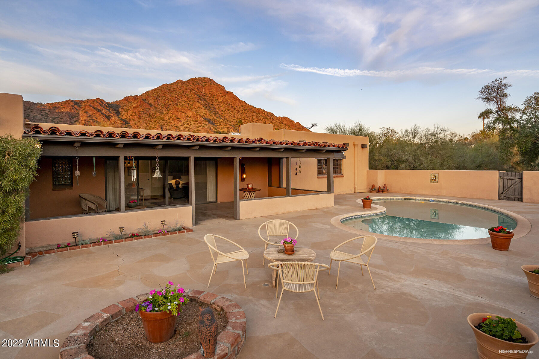 Once in a lifetime opportunity awaits! Built in 1956 this adobe style home sits on 1.5+ acres at the base of iconic Camelback Mountain. Blues, purples and golds highlight the skies each evening with spectacular mountain views. Warm and welcoming, the home is filled with charm and character that stands the test of time. Each ensuite bedroom has original handmade tiles with views of Camelback Mountain or the private, spacious backyard. Massive living room, highlighted with beams, wood burning fireplace and up close views of Camelback. Private dining room and kitchen also look towards Camelback. The family room with large sliders, fireplace leads to a patio, pool and massive natural desert oasis. This special private retreat is so close to Scottsdale, downtown Phoenix but feels worlds away.