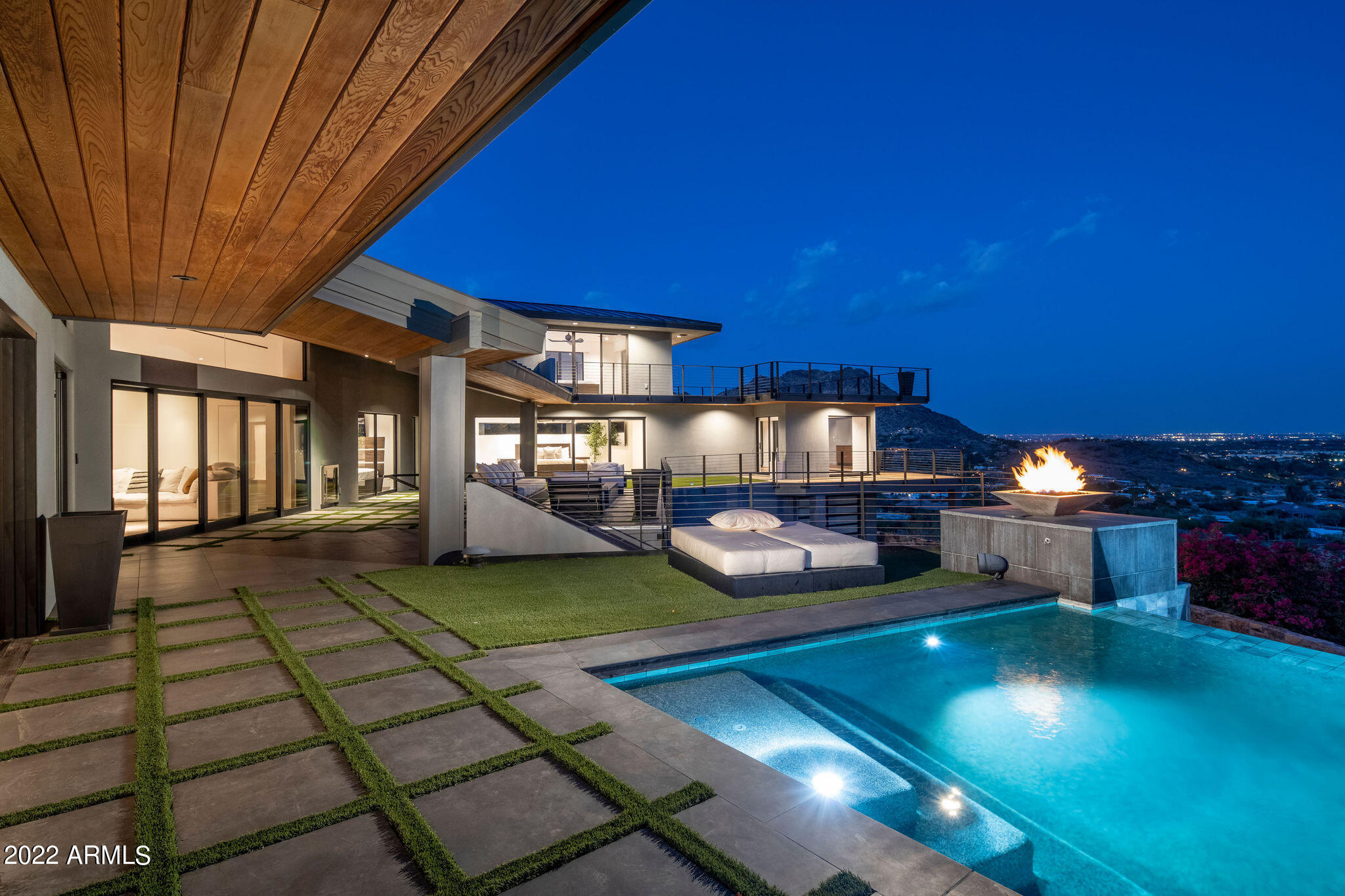 An inspired mountainside estate that elegantly combines modern design with symmetrical lines and eccentric artistic illustration. This home has unmatched views that go on forever. The open floor plan offers first-class entertaining possibilities with a stunning gourmet kitchen and a heavenly master retreat. The sensational wall of windows, private mountaintop location, and extraordinary architecture designed by the award winning architect, Gordon Rogers, will take your breath away.