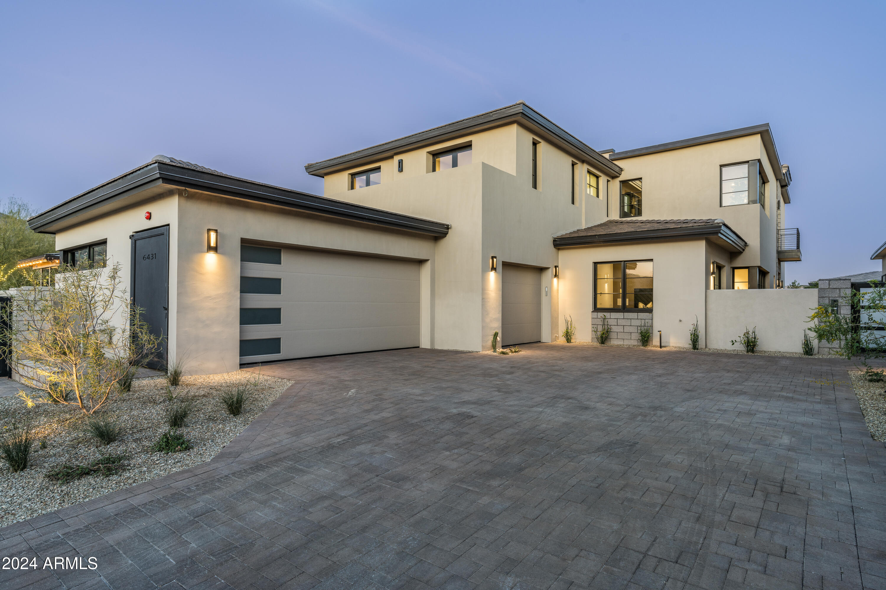 MODERN OPULENCE IS A HOME IS BEING SOLD TURN-KEY READY WITH DESIGNER FURNISHINGS BY CULLUM HOMES! ENTERING THROUGH THE PRIVATE COURTYARD OF THE LAST REMAINING HOME IN THE COMMUNITY WILL BE THOUGHTFULLY LANDSCAPED FOR A WELCOMING ENTRANCE. THE IRON AND GLASS DOOR LEADS YOU INTO THE VAULTED GREAT ROOM WITH 2 STORY FIREPLACE WALL, CHEFS KITCHEN, WET BAR, AND DINING ROOM. THE KITCHEN AND WET BAR IS ADORNED WITH NUMEROUS SUB-ZERO, WOLF AND COVE APPLIANCES. THE INCREDIBLE ATTENTION TO DETAIL IN THE ALL THE FINISHES IN THIS HOME WERE CHOSEN BY CULLUM HOMES INTERIOR DESIGN TEAM. THE RETRACTABLE WALL OF GLASS AND 2-STORY CLERESTORY GLASS MAKE THIS HOME SO LIGHT AND BRIGHT. THE PRIMARY SUITE IS SO COMFORTABLE WITH VIEWS OVER THE BACKYARD FOUNTAIN AND ENTERTAINING AREA. A SMALL GUEST SUITE WITH OWN ENTRANCE, LAUNDRY, POWDER BATH, ELEVATOR AND 3 AIR-CONDITIONED GARAGES MAKE UP THE FIRST FLOOR. THE IMPRESSIVE STAIRCASE AND LARGE WINDOW TO THE UPSTAIRS LANDING OVERLOOKING THE ENTRANCE AND GREAT ROOM WAS THE VISION OF THE CULLUM ARCHITECT TEAM. THE GLASS OFFICE EN-SUITE HAS VIEWS TOWARD CAMELBACK MOUNTAIN. THE LARGE LOFT AREA WITH CUSTOM BUILT IN CABINETRY LEAD TO THE COVERED DECK WITH GREAT VIEWS OF MUMMY MOUNTAIN! 2 LARGE EN-SUITES WITH BEAUTIFUL CUSTOM FINISHES AND WALK OUT DECK WITH CAMELBACK MOUNTAIN VIEWS COMPLETE THE SECOND LEVEL.  PLENTY OF STORAGE IN THIS 4-BEDROOM, 4 FULL BATHS, 1 POWDER BATH, OFFICE, GREAT ROOM, CHEF'S KITCHEN, DINING ROOM, WET BAR, LOFT  AND 3 CAR AIR CONDITIONED GARAGE. THIS HOME IS LOCATED IN THE 24-HOUR GUARD GATED COMMUNITY OF THE VILLAGE AT MOUNTAIN SHADOWS WITH ITS PARK, COMMUNITY POOL AND ACCESS TO THE MOUNTAIN SHADOWS RESORT AND ALL ITS AMENITIES AT YOUR DOORSTEP. A GREAT LOCK AND LEAVE HOME FOR THE WHOLE FAMILY!