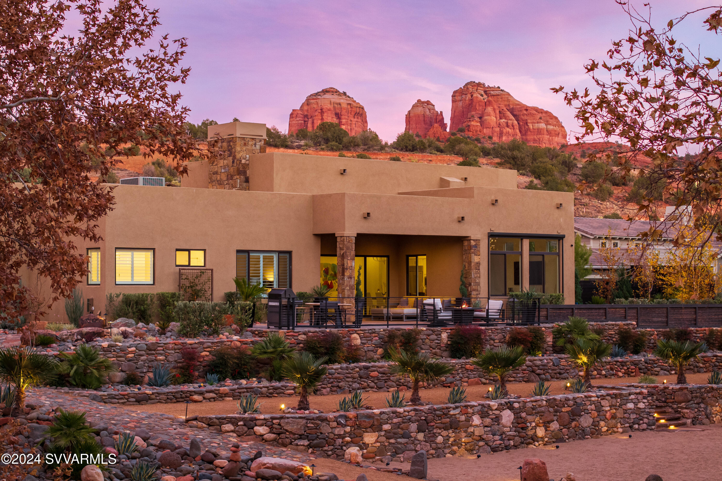 Indoor outdoor living redefined; luxury Sedona Living. Located in the exclusive gated community of Sedona Ranch, this stunning property seamlessly blends luxury and beauty with peace and serenity. The living room flows into a sleek kitchen with Wolf appliances, sparkling white cabinets, and a center island with bar seating. A versatile dining and lounge space sets the scene for many fun nights to come. Just beyond sliding glass doors in the living room, the resort-style backyard awaits with impeccable stonework, lush greenery, a covered patio, and views of your private Oak Creek access. Back inside, the spacious main suite offers dual vanities, a soaking tub, and a walk-in shower. Two additional bedrooms and a private casita create the perfect floor plan for your dream daily life.