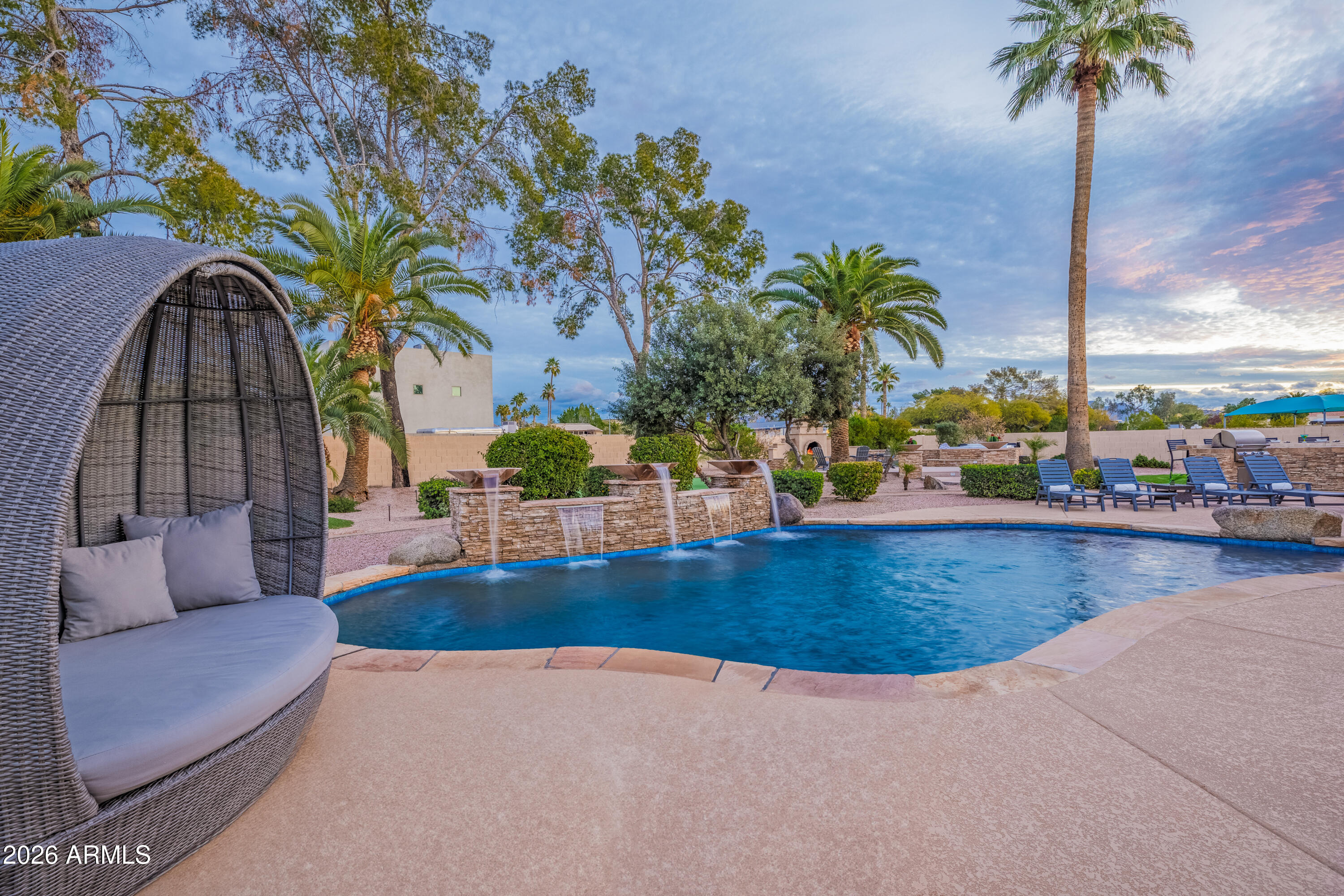 Imagine a backyard that rivals a private resort--lush, peaceful, and incredibly private on a rare 26,000+ SF cul-de-sac lot. A charming cobblestone entry framed by mature rose bushes welcomes you into this beautifully maintained home featuring multiple living spaces, including separate family and living rooms designed for comfort and entertaining. The attached casita, currently used as a second primary suite and game room, offers excellent flexibility for guests, multigenerational living, or a private retreat. Recent upgrades include fresh exterior paint and two new AC units. Surrounded by continued luxury growth and new development, this location offers both lifestyle and long-term value. Minutes from Kierland, Scottsdale Airport, dining, and shopping - - Welcome Home!