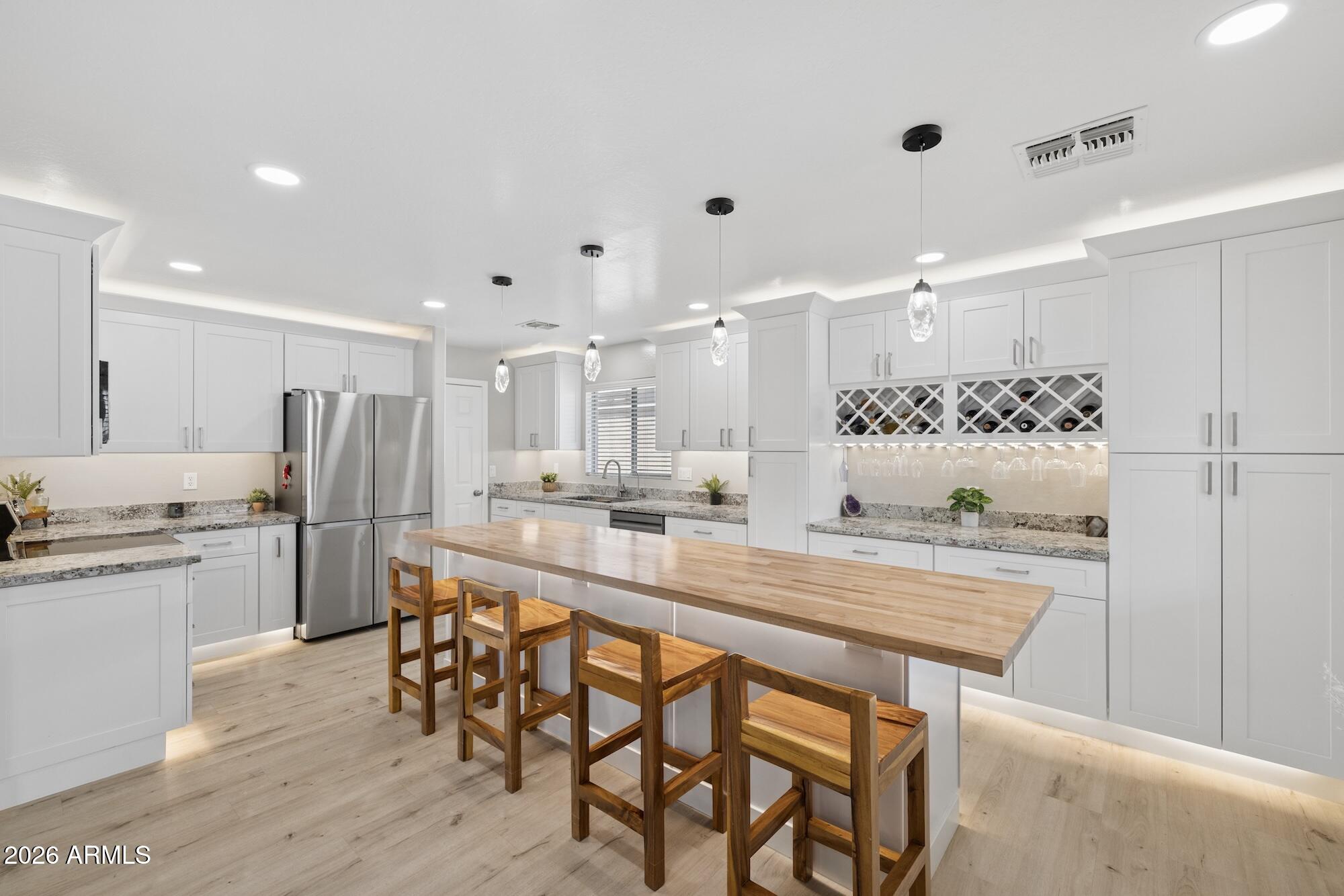 ASSUMABLE 3.25% LOAN - offering a rare opportunity for substantial monthly savings! Freshly repainted Inside and out (Aug. 2025) with a clean pre-listing inspection, this move-in ready 5-bed + loft, 3-bath home has been thoughtfully renovated with over $100,000 in upgrades.
The heart of the home is the stunning 2024 remodeled kitchen featuring extended butcher block island, granite countertops, custom cabinetry, and new appliances-perfect for entertaining or everyday living. The open floor plan flows effortlessly into the spacious living area, while the downstairs bedroom and full bath provide ideal space for guests, multi-generational living, or a private home office.
Upstairs, the versatile loft offers endless possibilities as a media room, playroom, fitness space, or second living area. The beautifully remodeled primary suite is a true retreat with a custom tiled walk-in shower, upgraded vanities, designer lighting, and custom shelving. The guest baths have also been tastefully updated with modern finishes.
Additional upgrades include new flooring and trim throughout w/5" baseboards on lower level, whole-house water filtration and softener with r/o to the refrigerator, updated ceiling fans, and numerous thoughtful touches that make this home truly turnkey.
Step outside to your spacious, nearly maintenance-free backyard featuring covered patio, raised garden beds, mature landscaping, and newly planted trees--perfect for relaxing, entertaining, or enjoying Arizona evenings.
Conveniently located just minutes from Copper Sky Recreation Complex, Harrah's Ak-Chin Casino, shopping, dining, and the popular Duke's Roadhouse, this exceptional home combines comfort, style, and value. Don't miss this rare opportunity to own one of Senita's most beautifully updated homes!