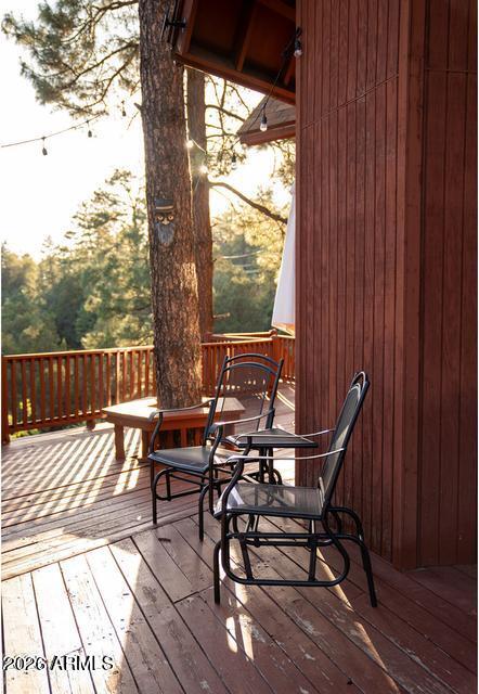 Welcome to this charming 4-bed, 3-bath mountain cabin nestled on .73 acres of tall Ponderosa pines. This home is being offered FULLY FURNISHED with BRAND NEW central air With 2,550 sq. ft., vaulted wood ceilings, tall windows, and an open kitchen/great room with fireplace, this home is filled with natural light and stunning views. The finished walk-out basement offers a private suite with bedroom, bath, and living area, while the upstairs loft provides extra space for sleeping or a home office. Enjoy the expansive deck, 2-car garage, and additional carport. With no HOA, this property is currently a cash-flow-positive short-term rental. A rare opportunity for a turnkey getaway or investment! Sellers also FULLY PAVED the driveway.