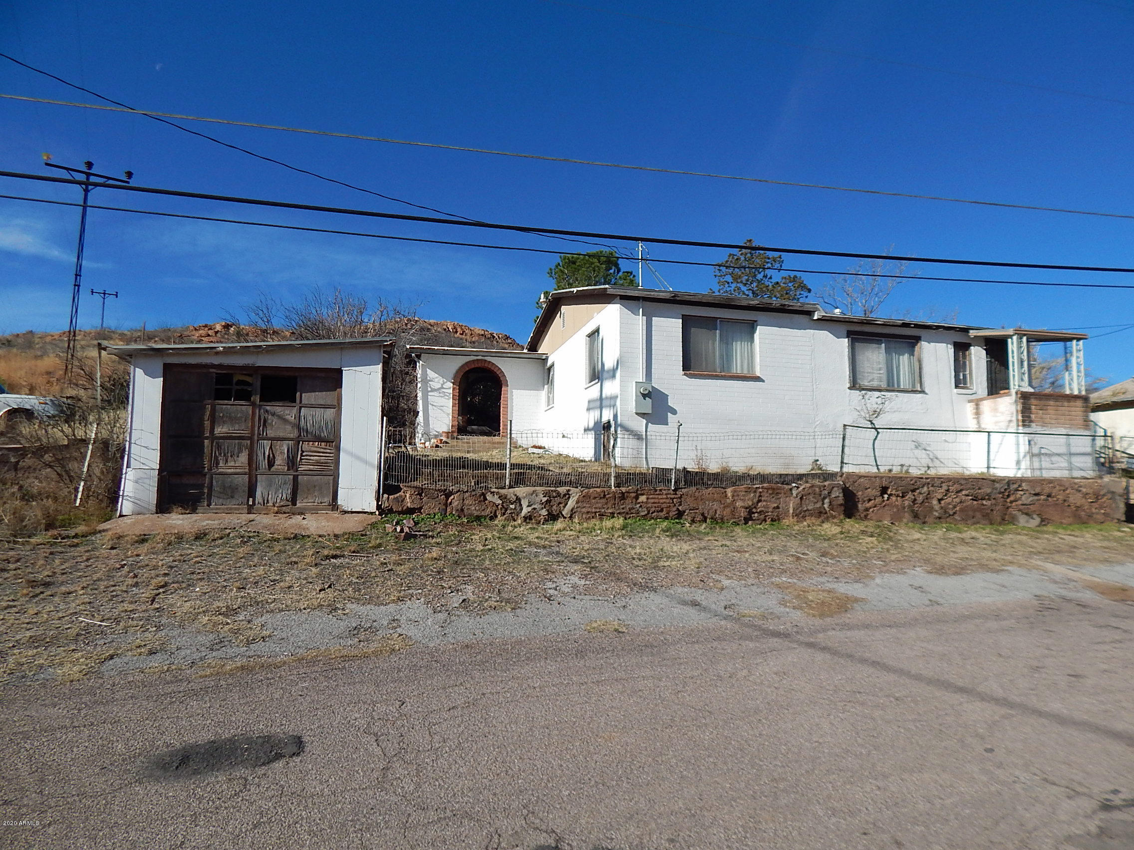 Priced to Sell!! With 2 parcels totaling .25 acres appx. this 3-bedroom 3/4 bathroom home has 1849 sq. ft under roof with a 160 sq. ft Arizona Room included. The kitchen is spacious and has 2 pass-throughs for your convenience. Just think about this: the beautiful porch/patio with Southwest inspired brick arches, is the perfect place for morning coffee as you plan your next project. After a long day, just relaxing would also be perfect. This home will DEFINITELY take some work, but it is priced right.  Parcel #'s are 102-05-055 and 102-05-056B.  The 2 vehicles are NOT included.
