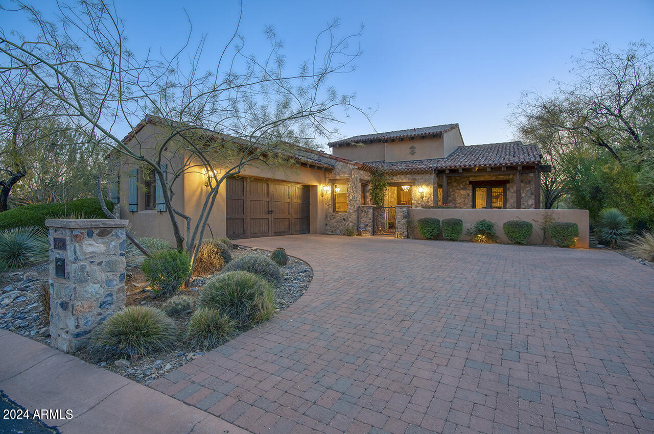 Featured in Phoenix Home and Garden magazine as rustic with a refined hand and contemporary with a Southwest aesthetic, this CSE Silverleaf Casita is sensible sophistication at its finest.  This relaxed ranch uses a mix of materials and influences bringing a fresh twist to Southwest style.  Brought to life by Jill Keig of acclaimed Wiseman & Gale Interiors.  An entertaining dream with open floor plan, rooms flowing from one to another opening with telescoping glass doors to the outdoor living spaces backing to open wash with southwest exposure featuring an alfresco dining room with fireplace, pool with water feature and spa, lounge area, eat in outdoor kitchen, firepit with sitting area, and manicured artificial turf.  Bringing nature indoors with reclaimed oak flooring, indigenous stone used to clad fireplaces both indoors and out, hand-hewn wood beams, knotty alder cabinetry, and copper sinks and faucetry all add to the home's distinctive character.  Eat in kitchen island boasting Viking and SubZero appliances, with stylish copper vent, with an appropriate back kitchen with wine frigdge, coffee maker, microwave and refrigerator.  Abounding with exclusive finishes including hand-woven Spanish cotton upholstered bath accent walls finished with large clavos, copper vanity and bucket sink, rawhide shades top chic iron scones, herringbone and brick lay tile flooring in baths, exquisite quartz and travertine slab countertops.  Pristine two car garage with additional lift and Lutron automative system.  Located in the coveted 32 home cove, conveniently located just off the drive to the Silverleaf clubhouse, "the Casitas" modeled after the Silverleaf clubhouse, are eminent in style and design, for the most discerning homeowner.