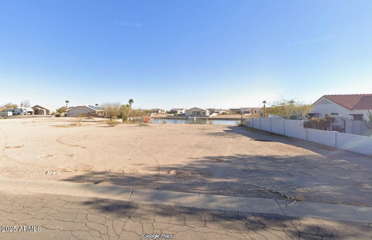 This lot is on Paradise Lake in Arizona City and ready for your next home!